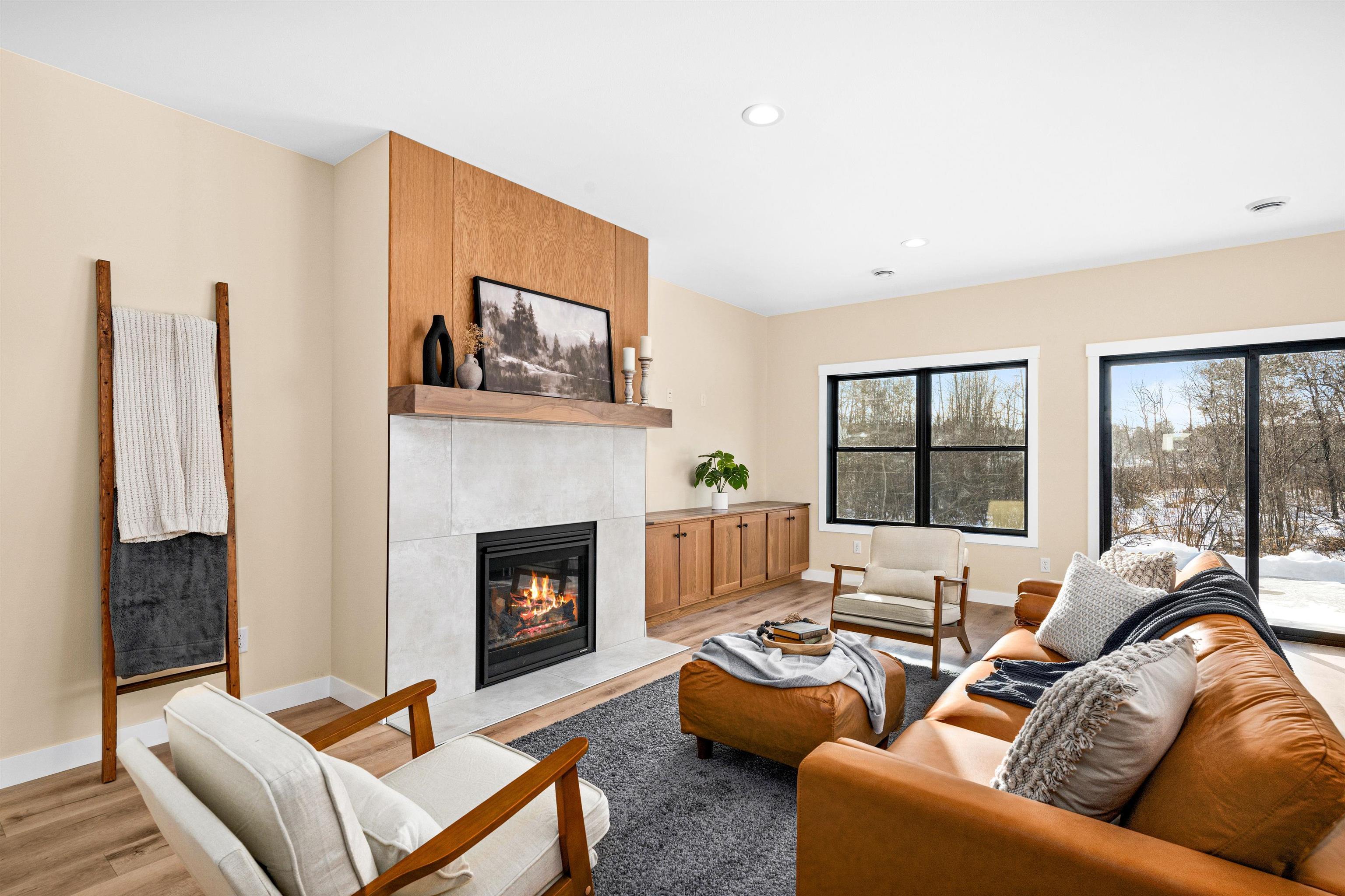 Image 2: Living room with a fireplace, wood finished floors, and recessed lighting, Living Room