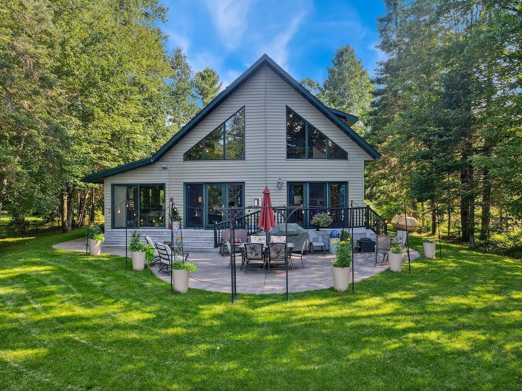 Image 0: Lake view of property with a patio and a yard, view from the lake