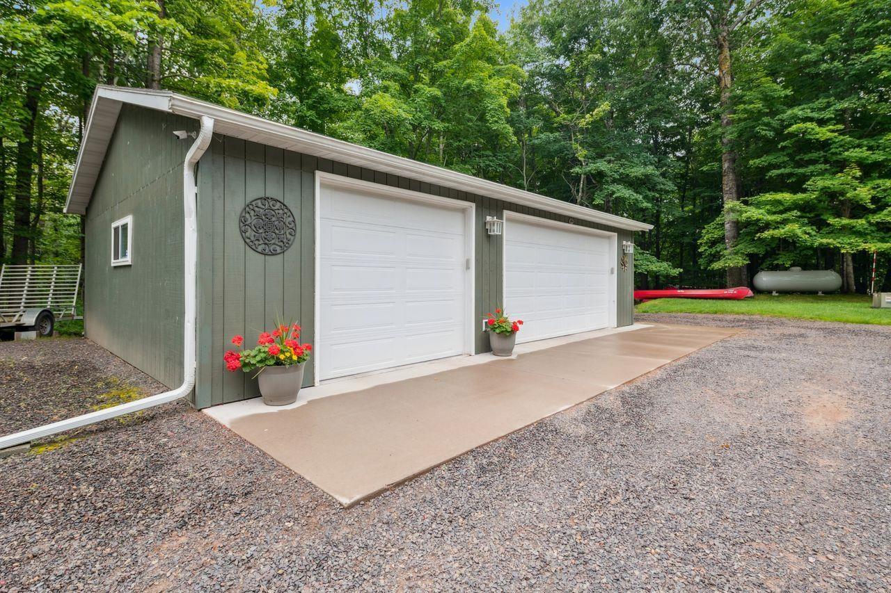 Image 3: Detached garage featuring view of scattered trees, Garage