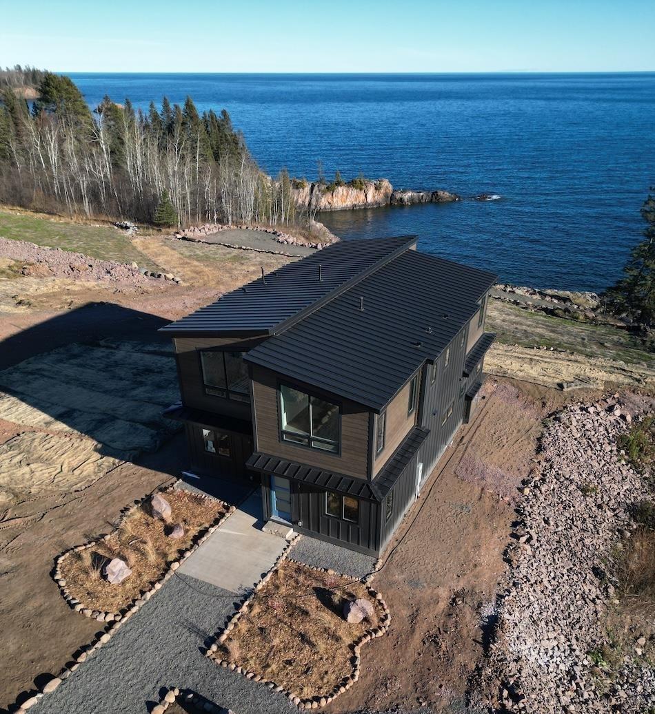 Image 2: Aerial view of property and surrounding area with a large body of water, Aerial View