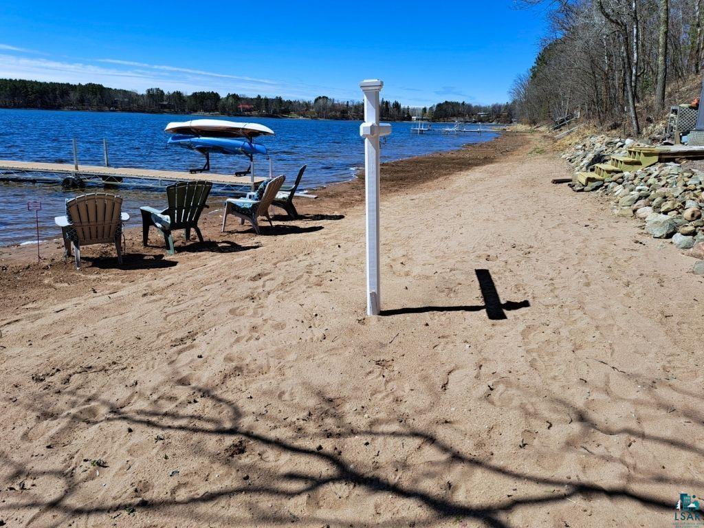 Image 3: Sandy shoreline property featuring a private dock and direct water access, View