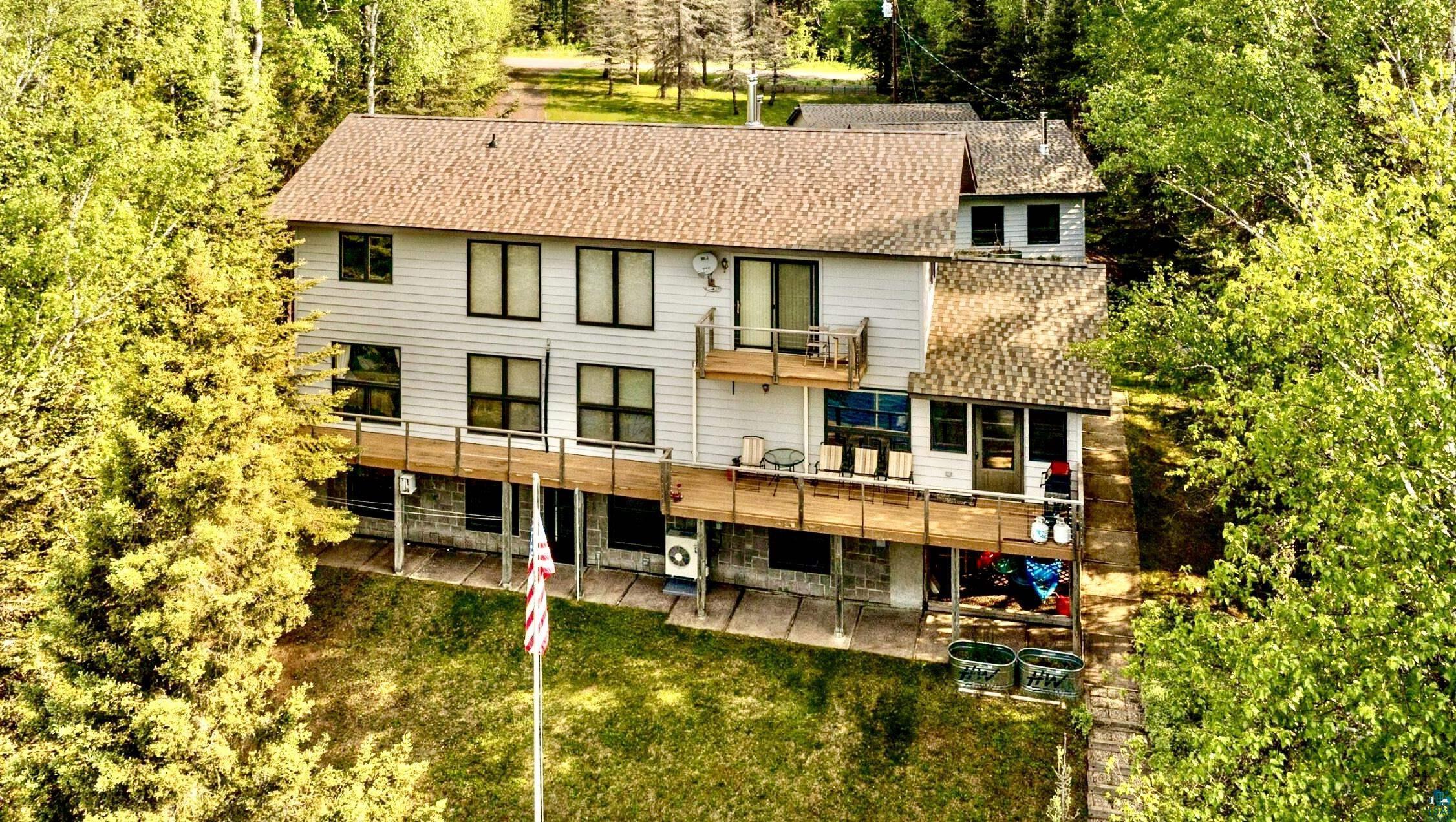 Image 3: Three Level Home featuring a yard, view of lake, decks and a patio, Three Level Home