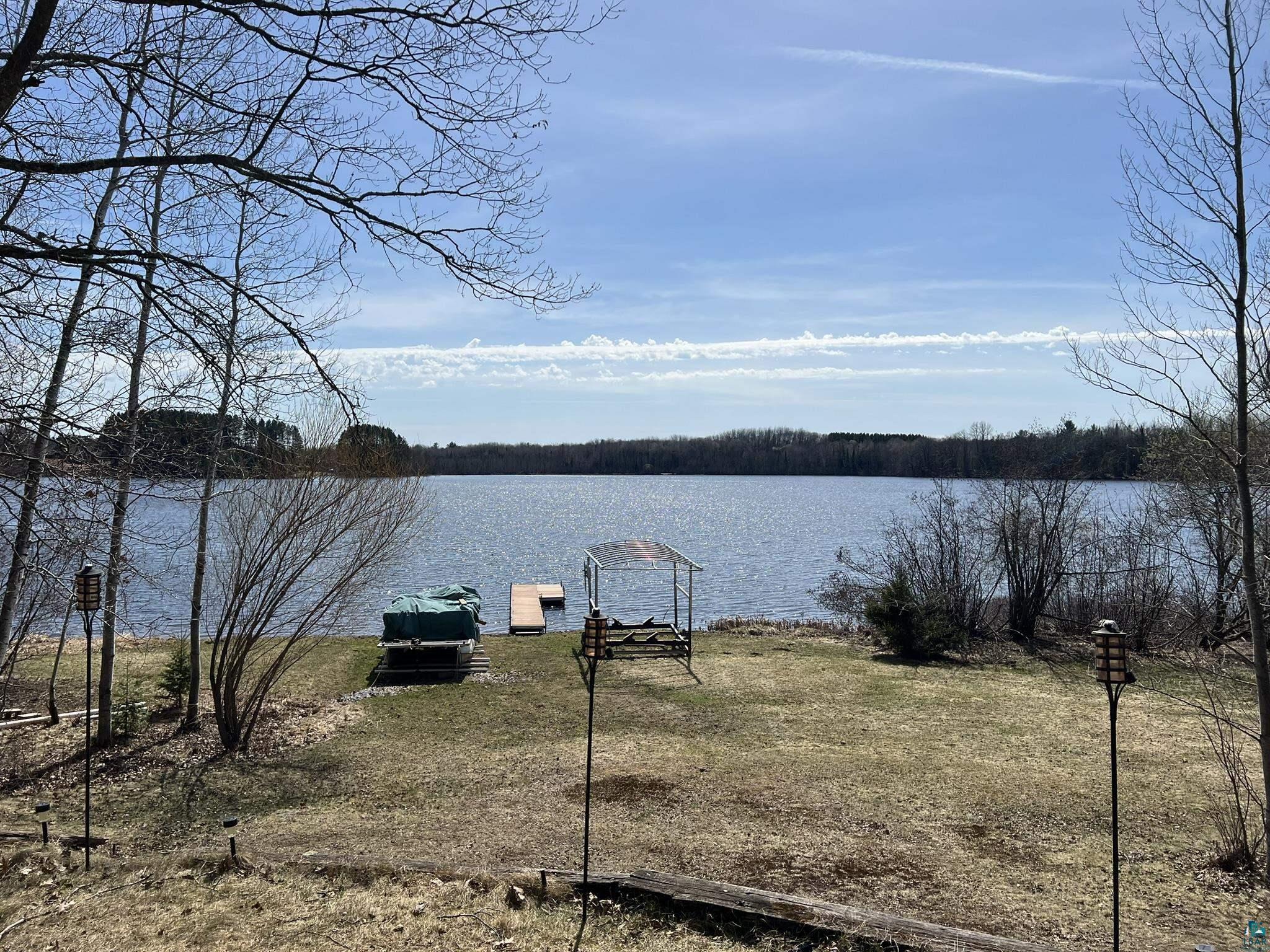 Image 2: Expansive lakefront property featuring a private dock, boat lift, and waterfront access, View