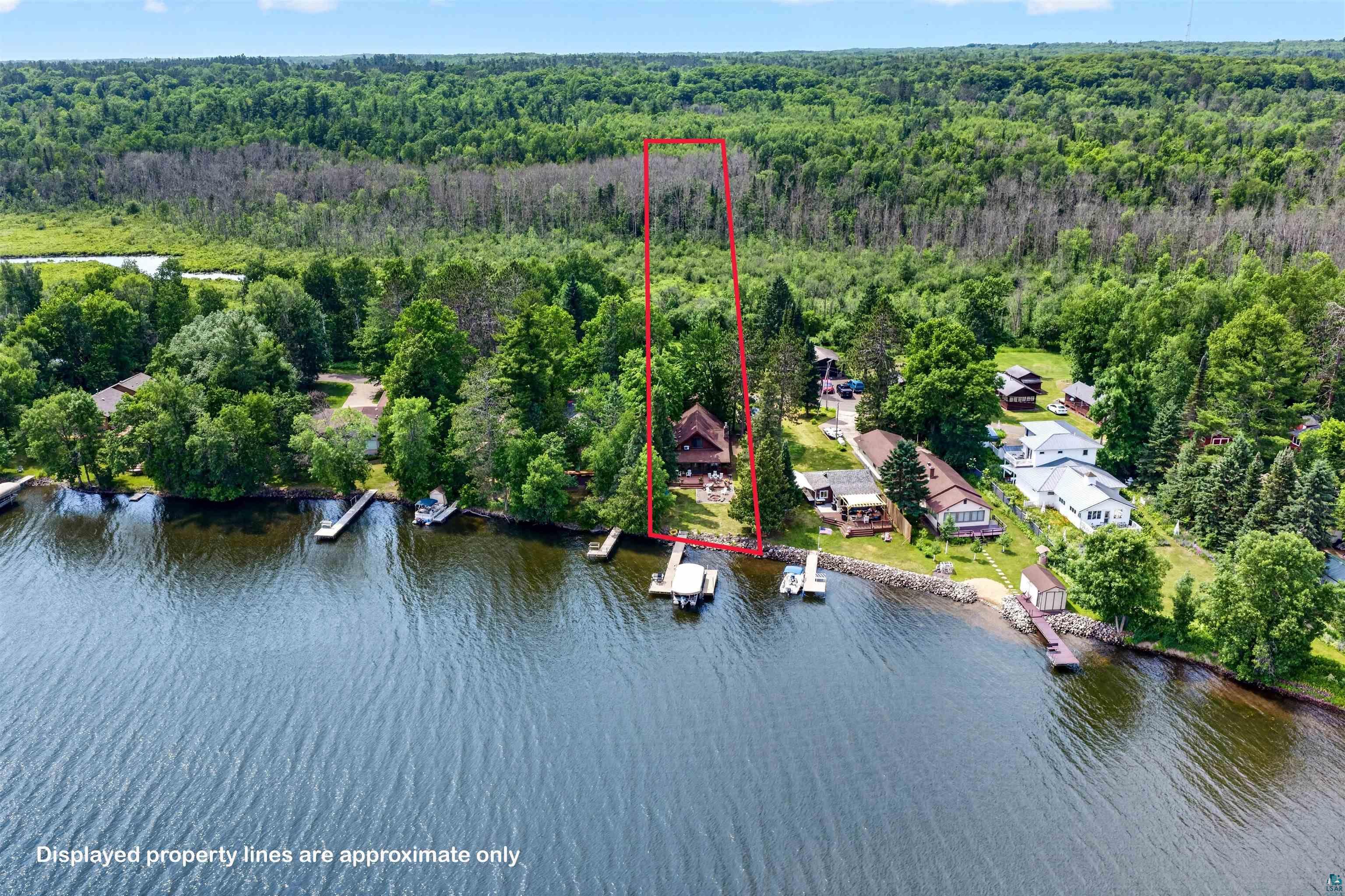 Image 1: Waterfront property featuring a private dock, mature trees, and direct lake access, Aerial View
