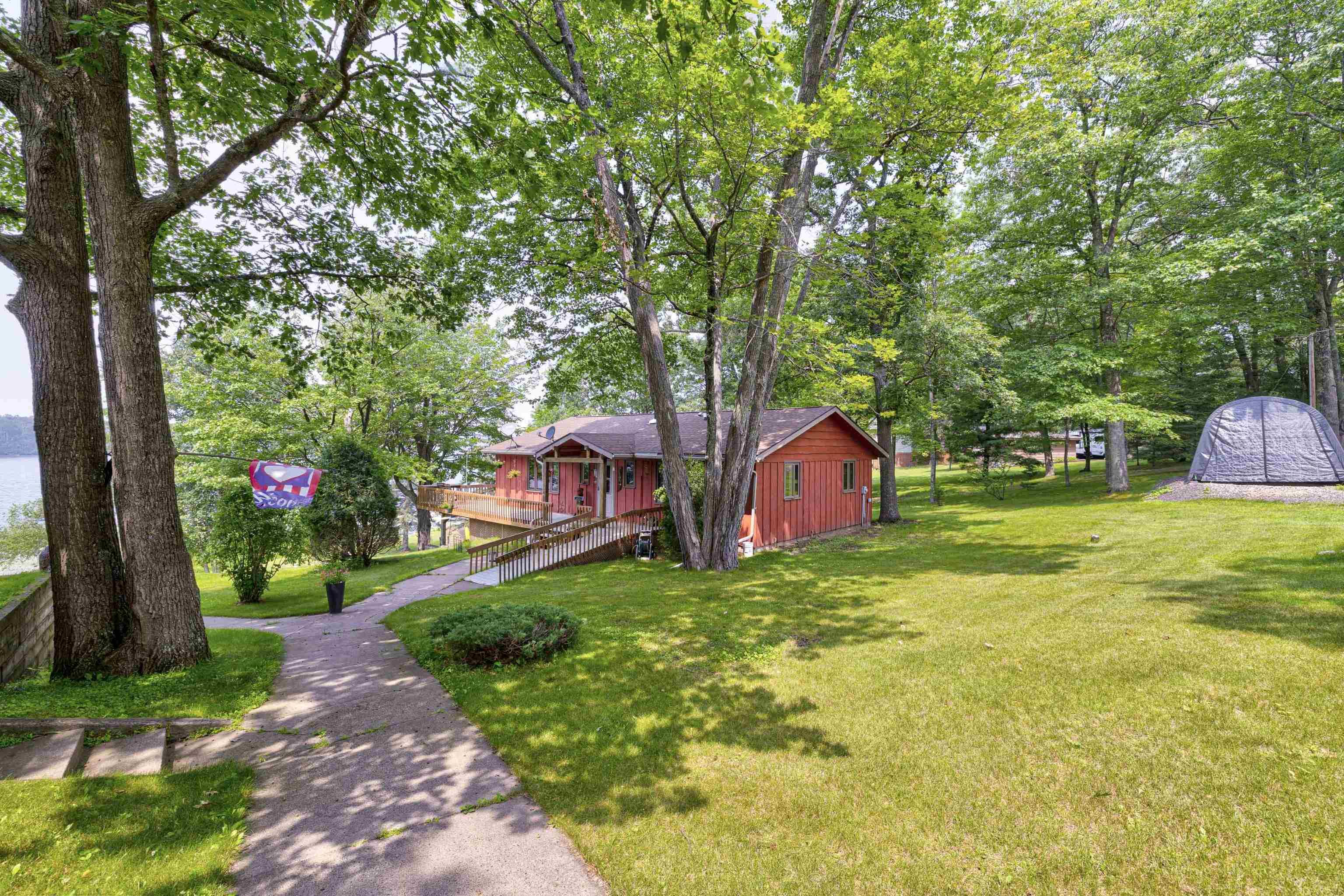 Image 1: View of green lawn featuring a deck, Yard