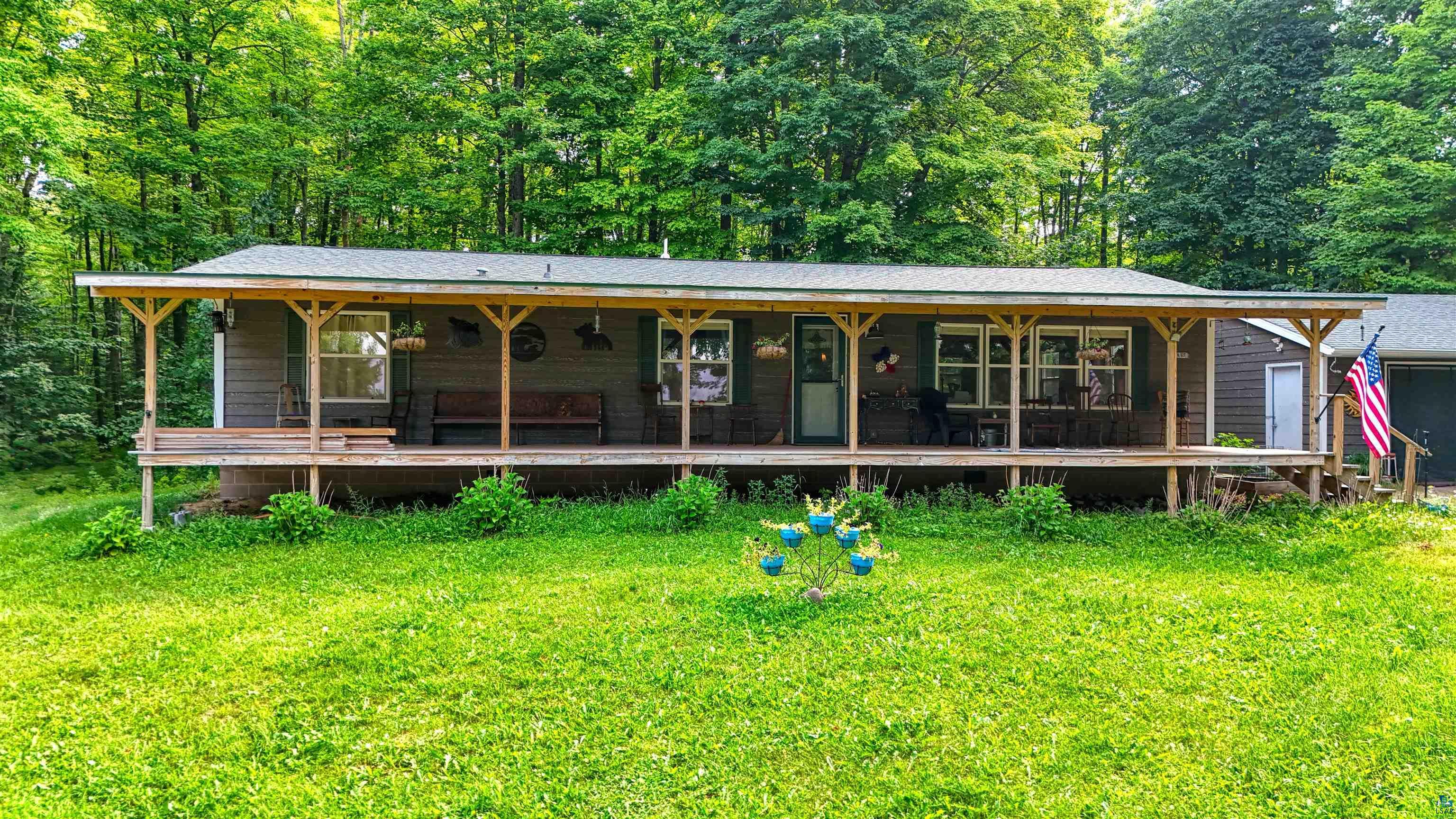 Image 2: View of front of property with covered porch, a front yard, and a shingled roof, Front Of Structure