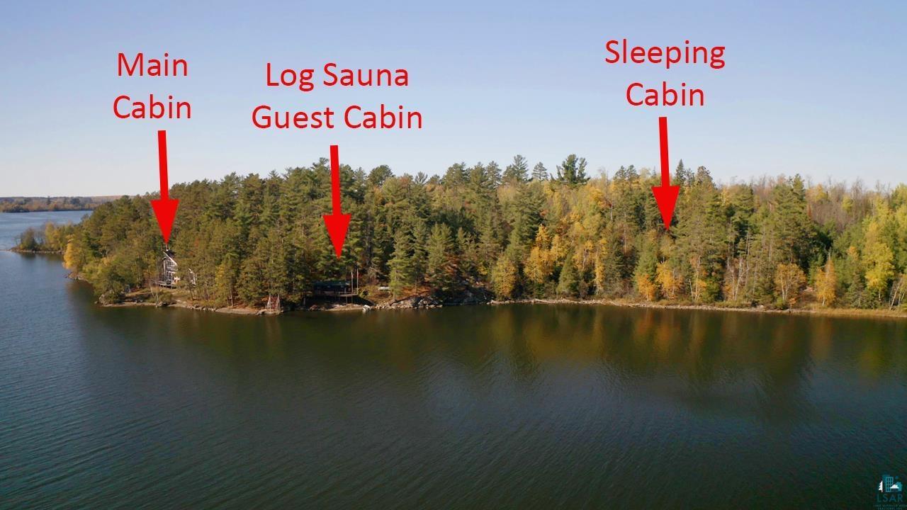 Image 1: Water view featuring a forest, View