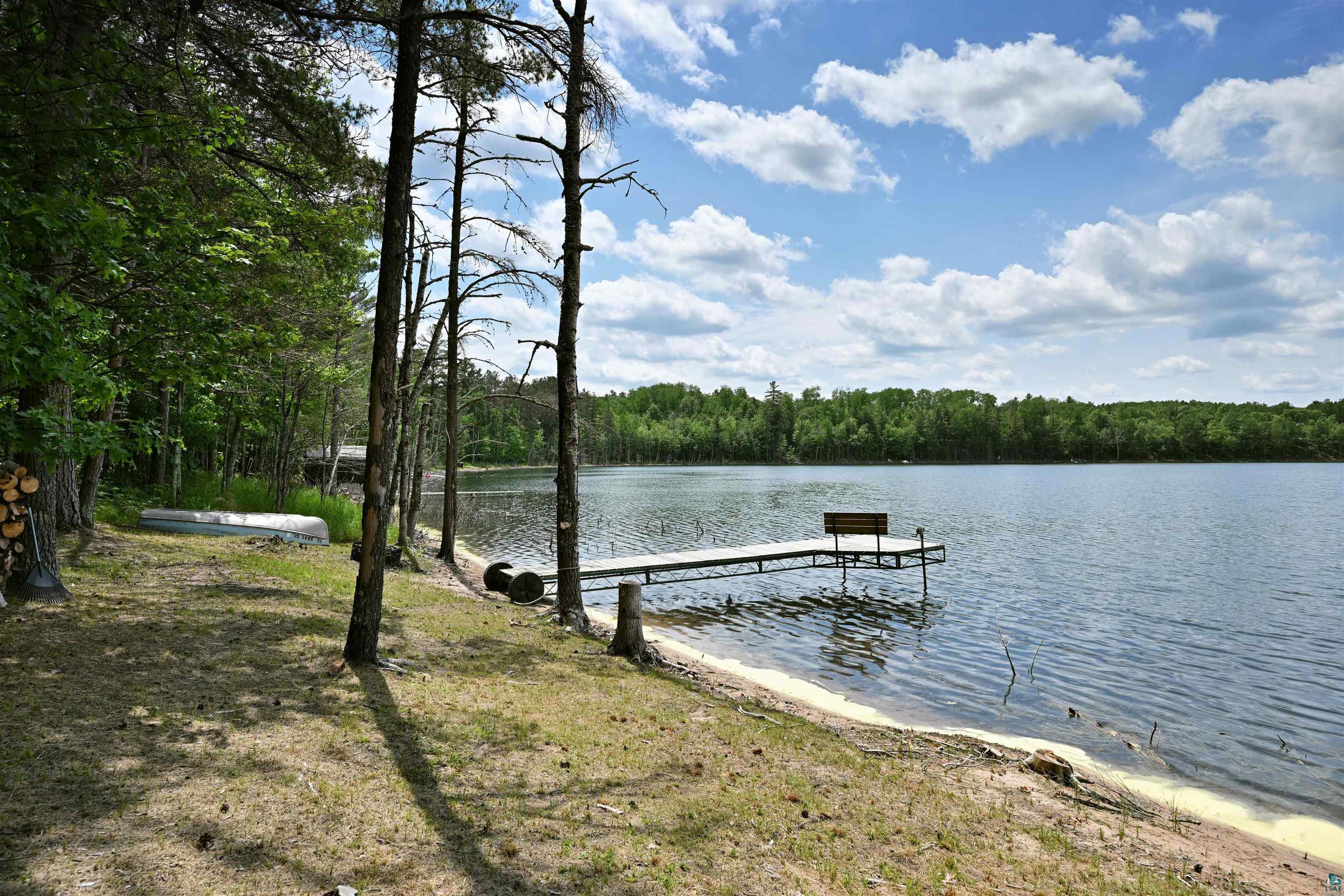 Image 3: Dock area featuring a forest view and a water view, Dock