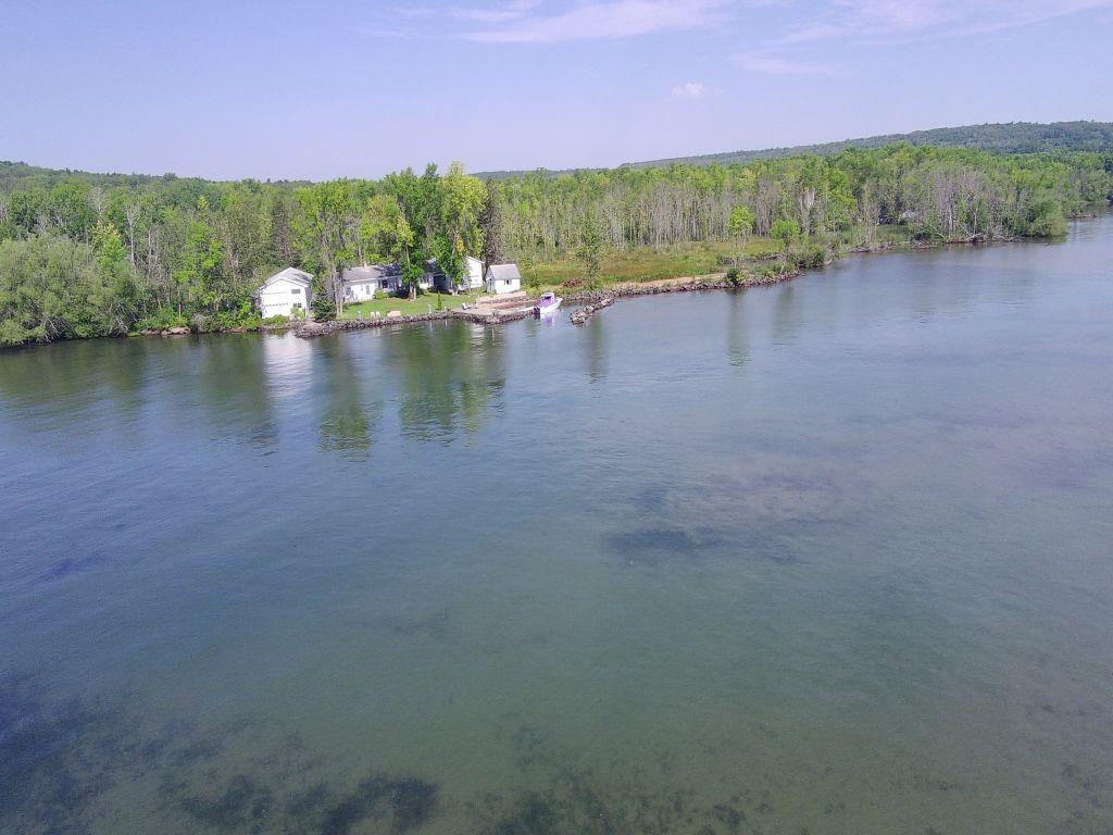 Image 2: Water view featuring a heavily wooded area, View