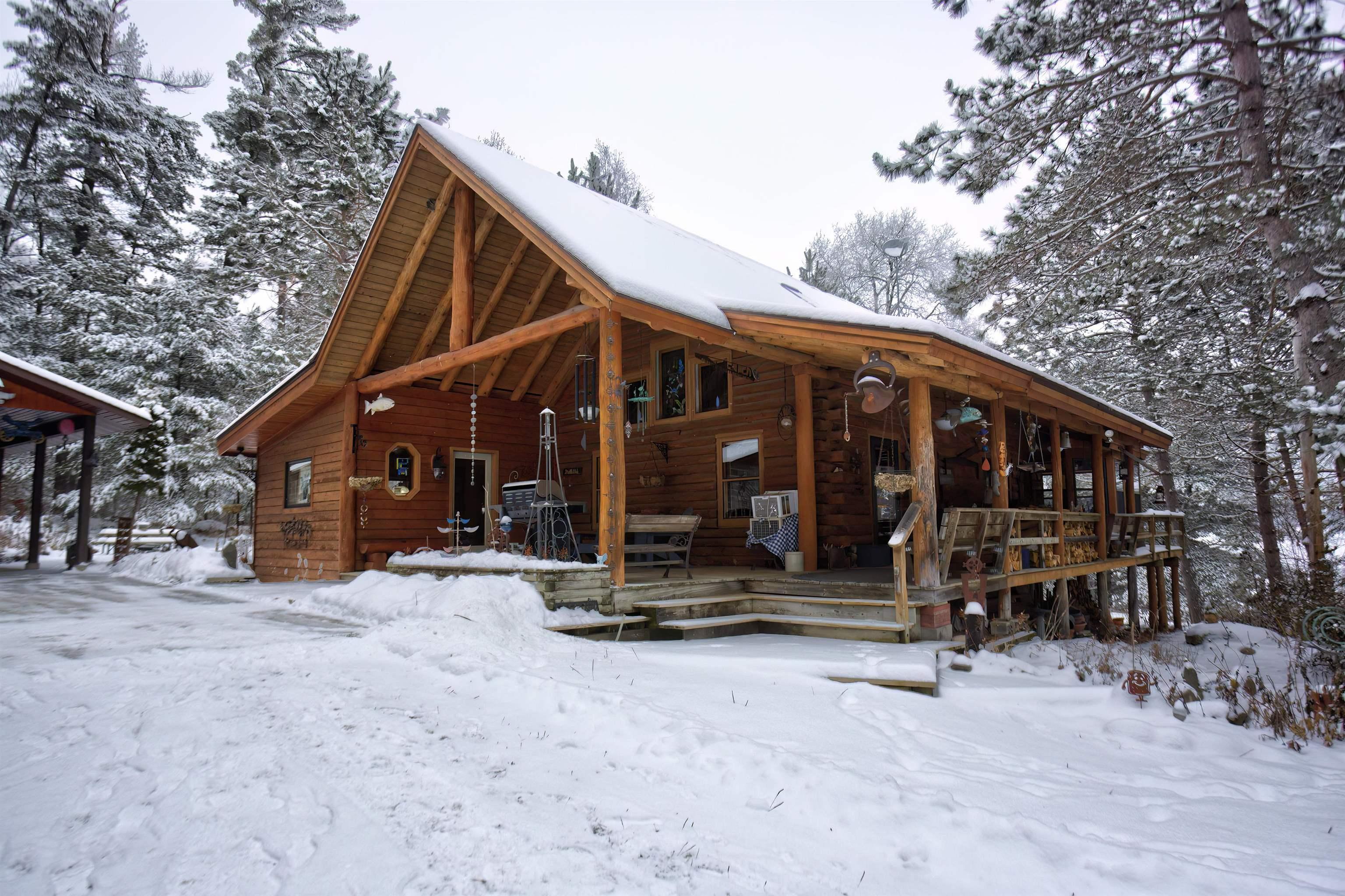 Image 2: Snow covered house featuring a porch, Back Of Structure