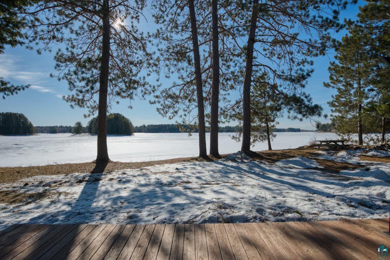 Image 1: Wooden terrace featuring a water view, Deck