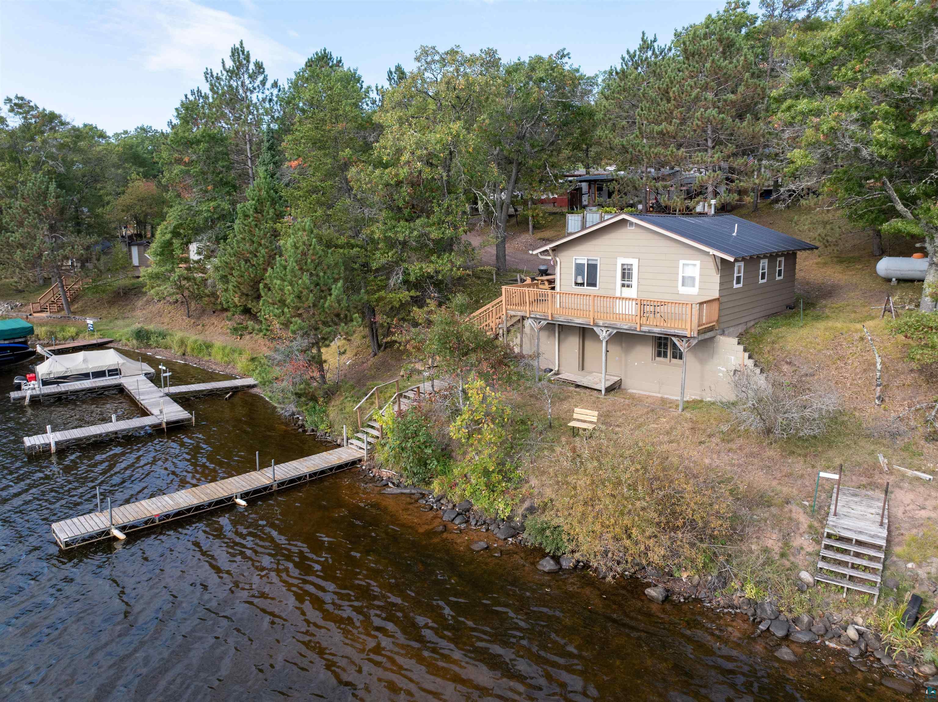 Image 2: Aerial view of property and surrounding area with a large body of water and a tree filled landscape, Aerial View