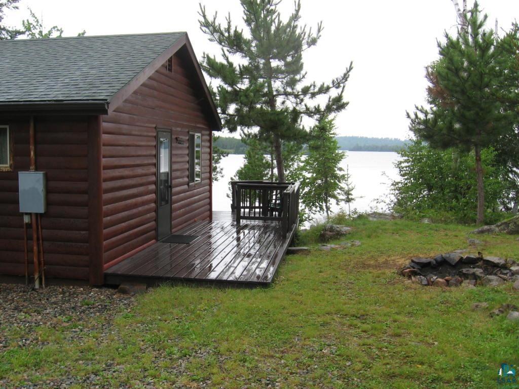 Image 2: deck with water view and a lawn