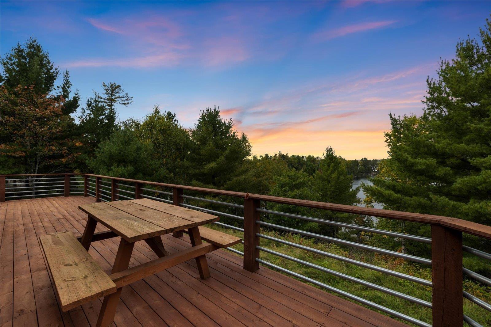 Image 3: Deck with a twilight view overlooking the lake, Deck