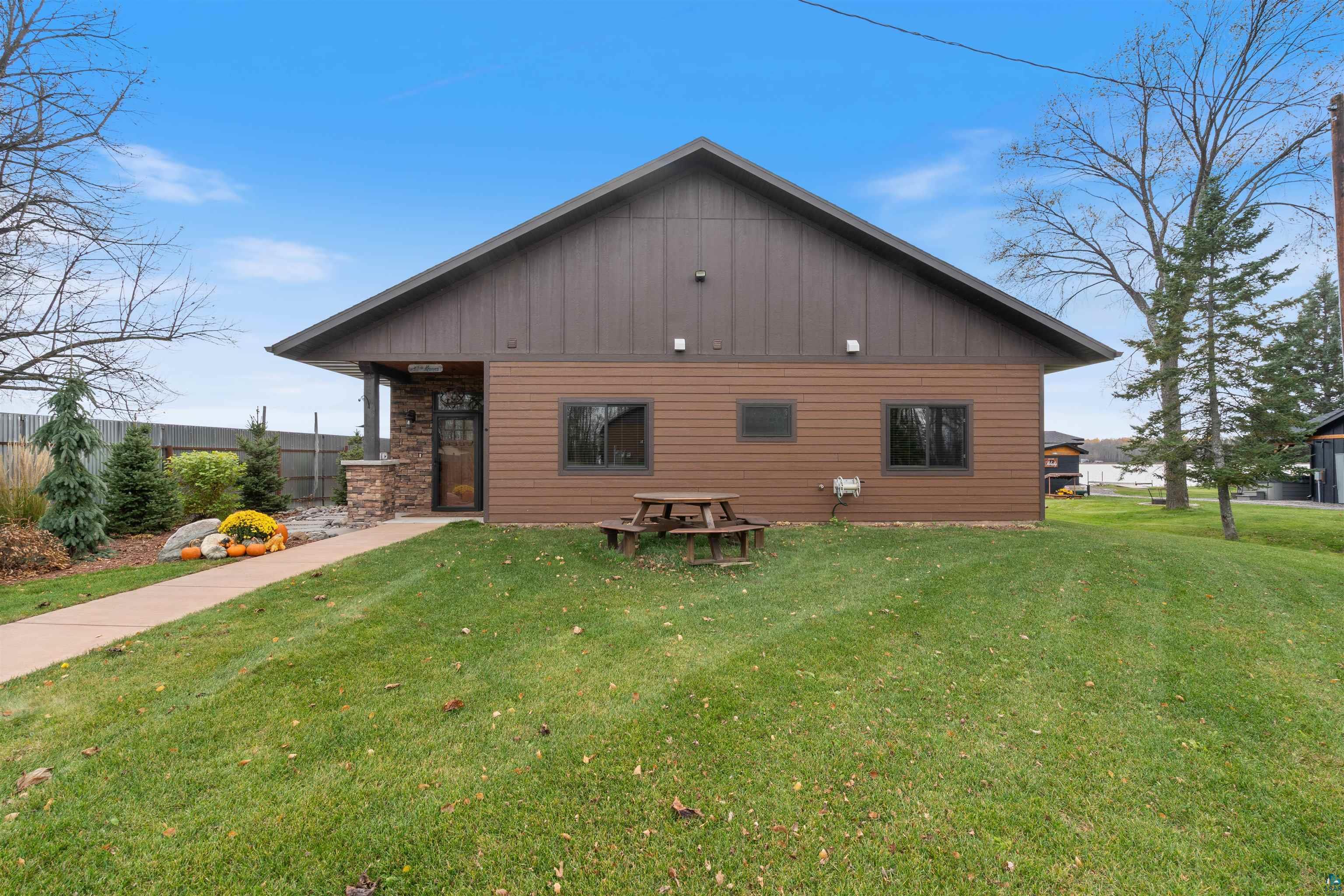Image 2: Back of property featuring a lawn and board and batten siding, Back Of Structure