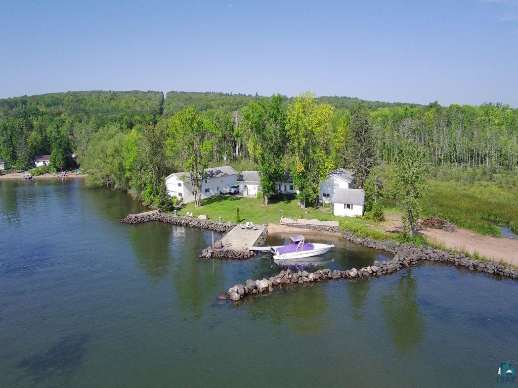 Image 1: Drone / aerial view of a large body of water and a heavily wooded area, Aerial View