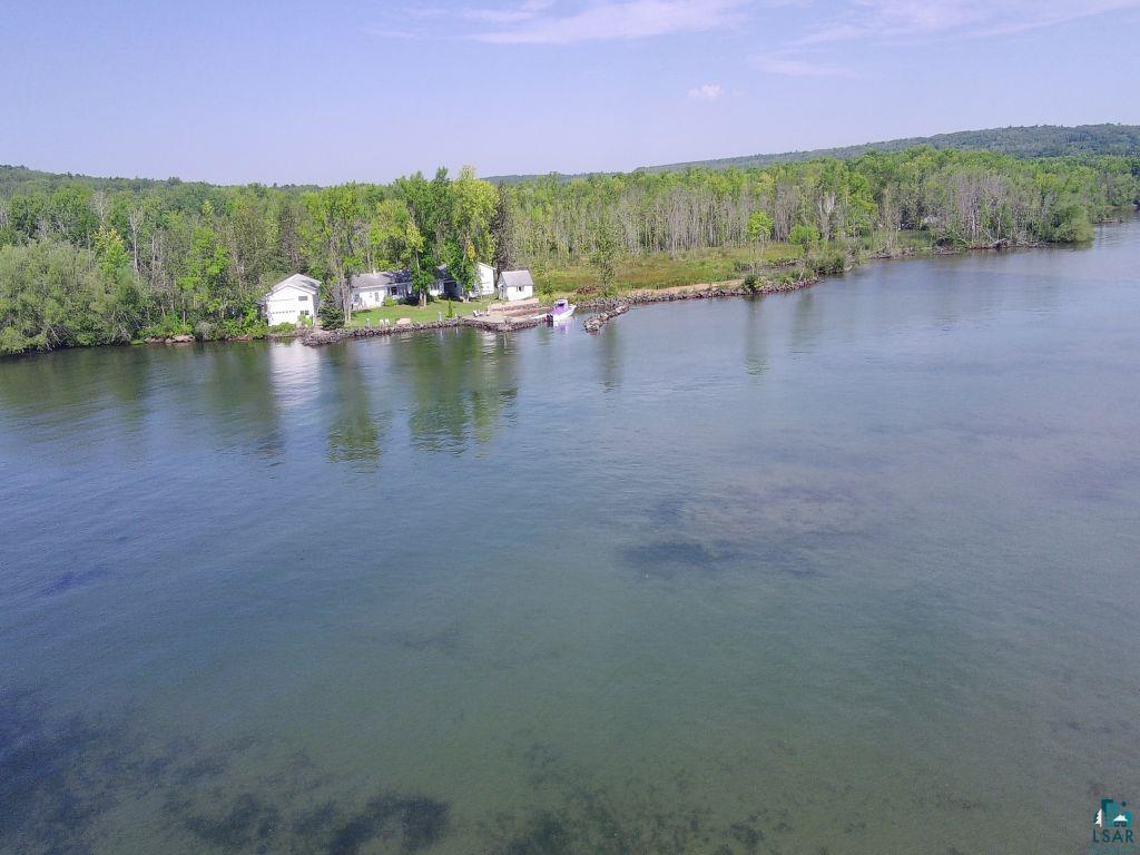 Image 2: Water view featuring a heavily wooded area, View
