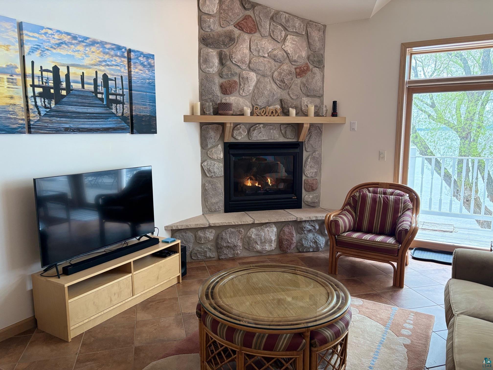 Image 2: Tiled living area with a stone fireplace, Living Room