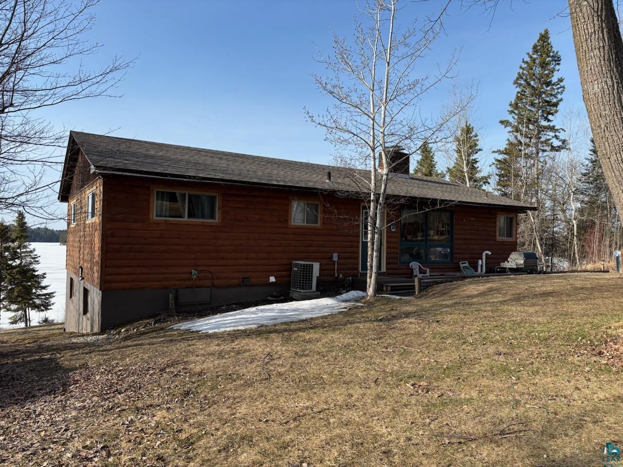 Image 2: Back of property featuring cooling unit, a chimney, a lawn, a shingled roof, and a patio, Back Of Structure