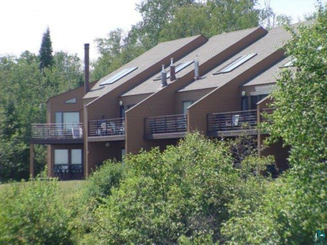 Image 0: Back of property featuring a balcony, Back Of Structure