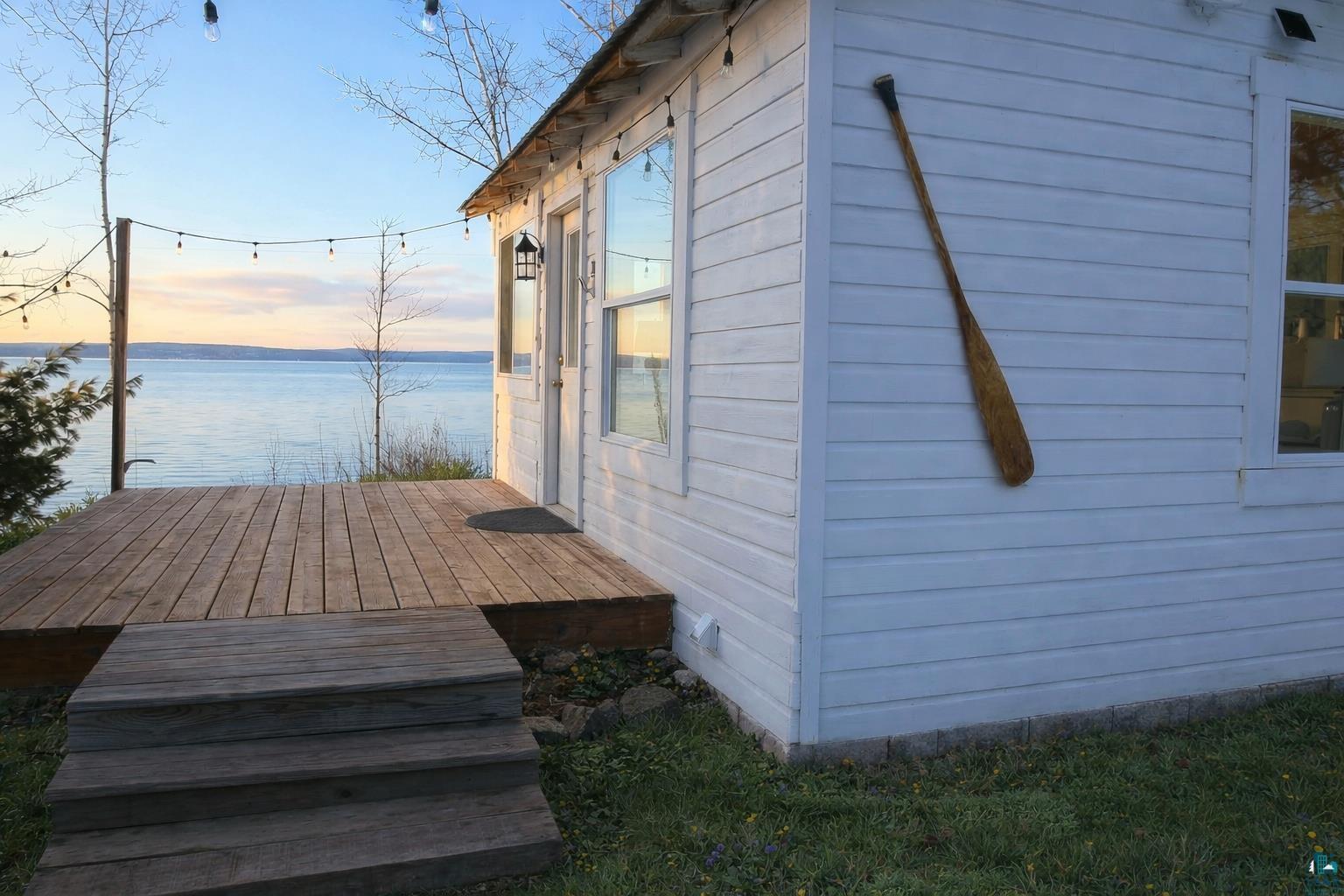 Image 1: View of home's exterior with a deck with water view, Side Of Structure