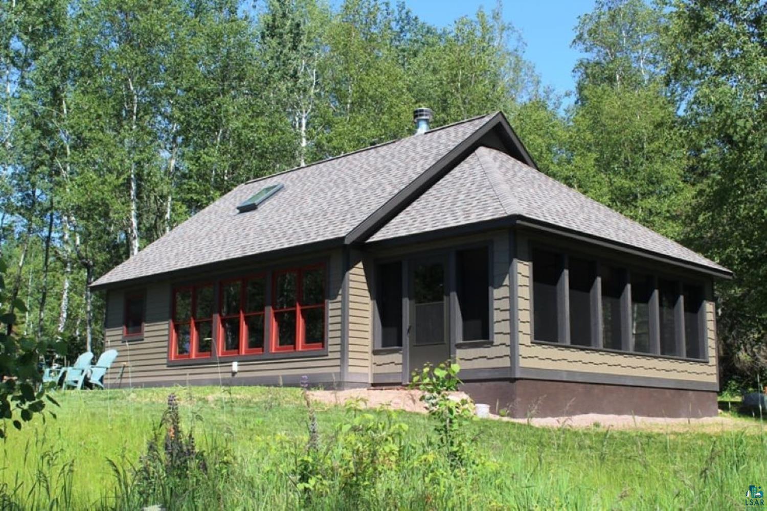 Image 1: Cottage-style residence featuring a screened porch and a skylight, Side Of Structure