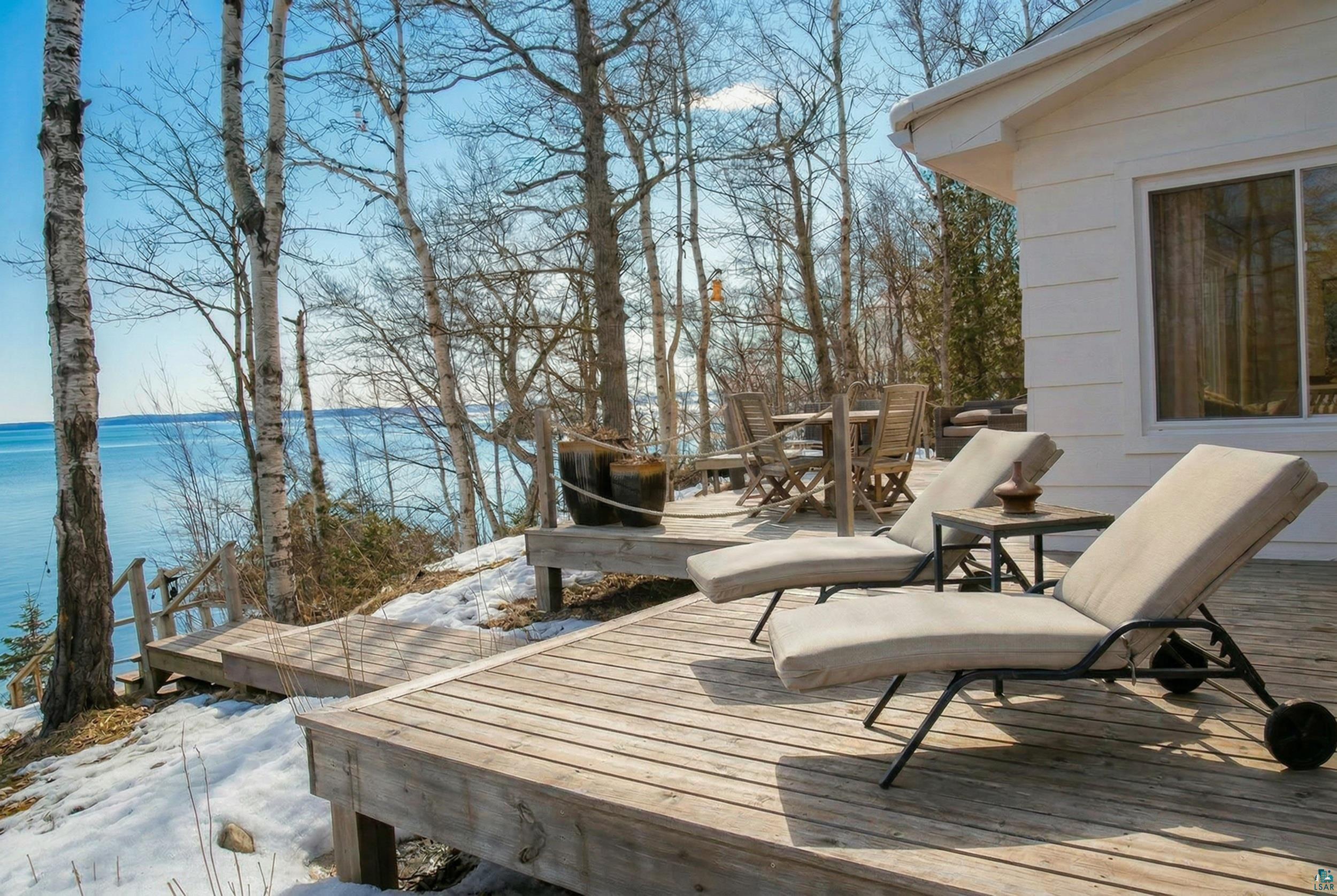Image 2: Wooden deck featuring a water view and outdoor dining space, Deck