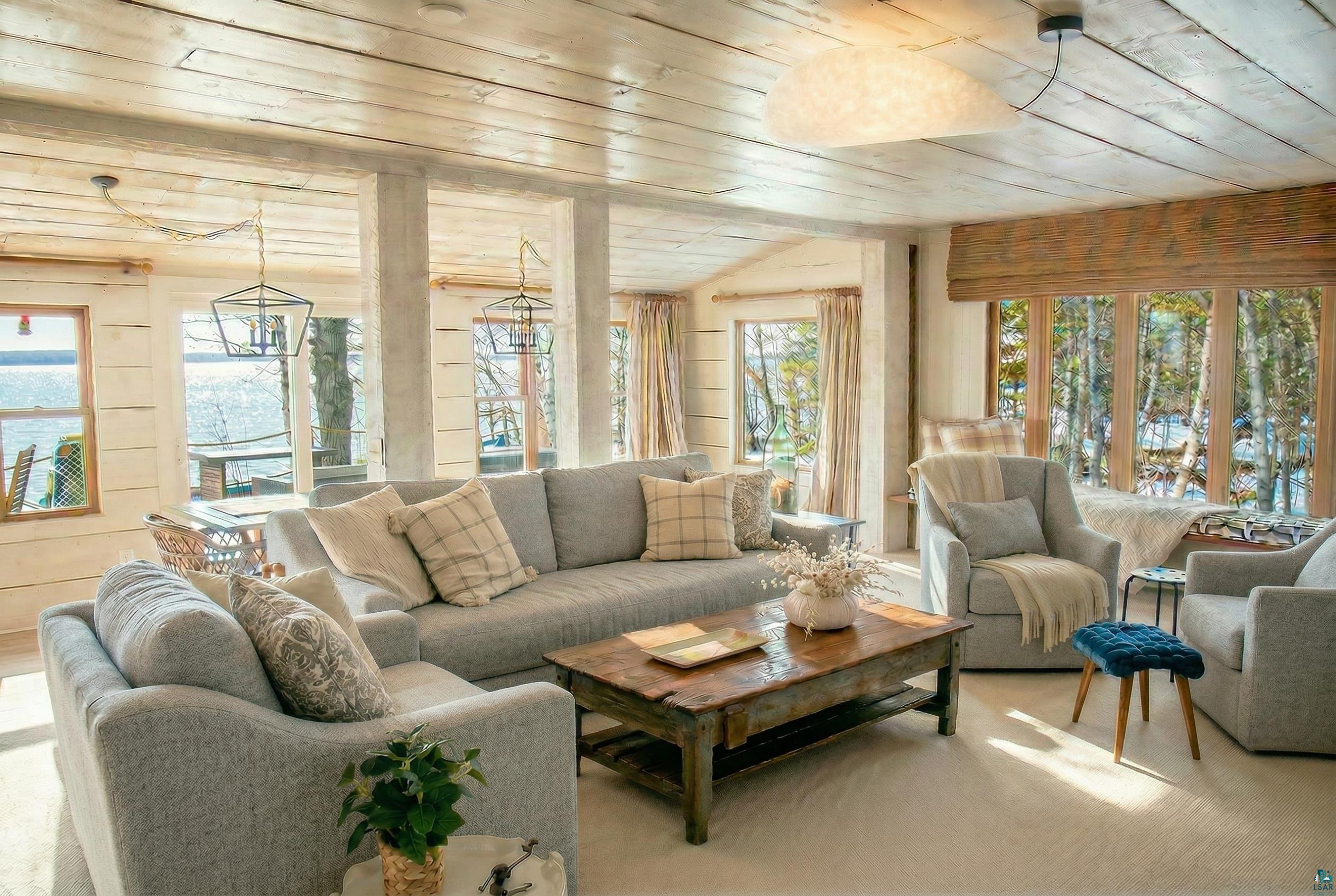 Image 3: Carpeted living area featuring a vaulted wooden ceiling and wooden walls, Living Room