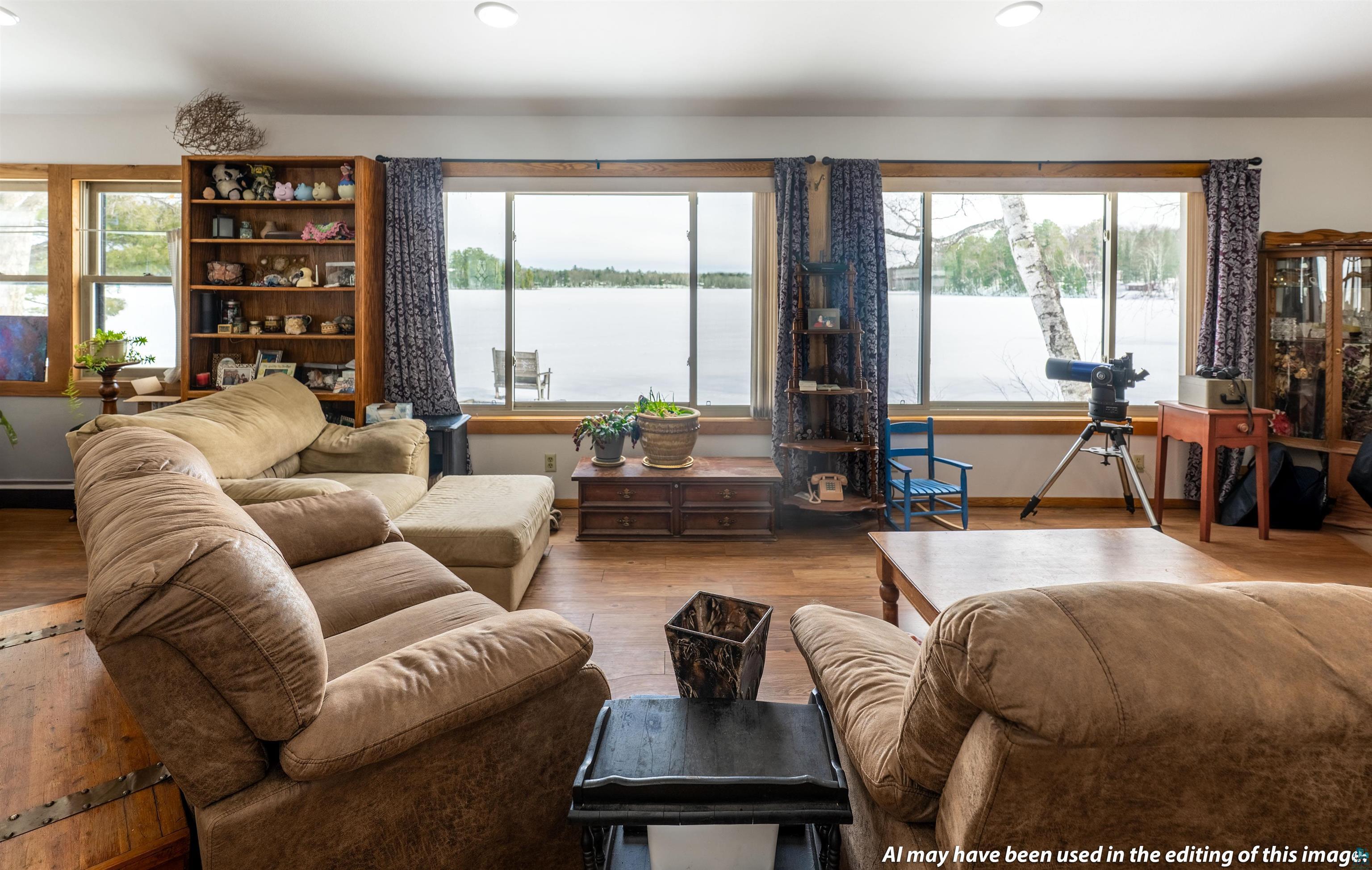 Image 3: Living area featuring hardwood / wood-style floors, a water view, plenty of natural light, and recessed lighting, Living Room