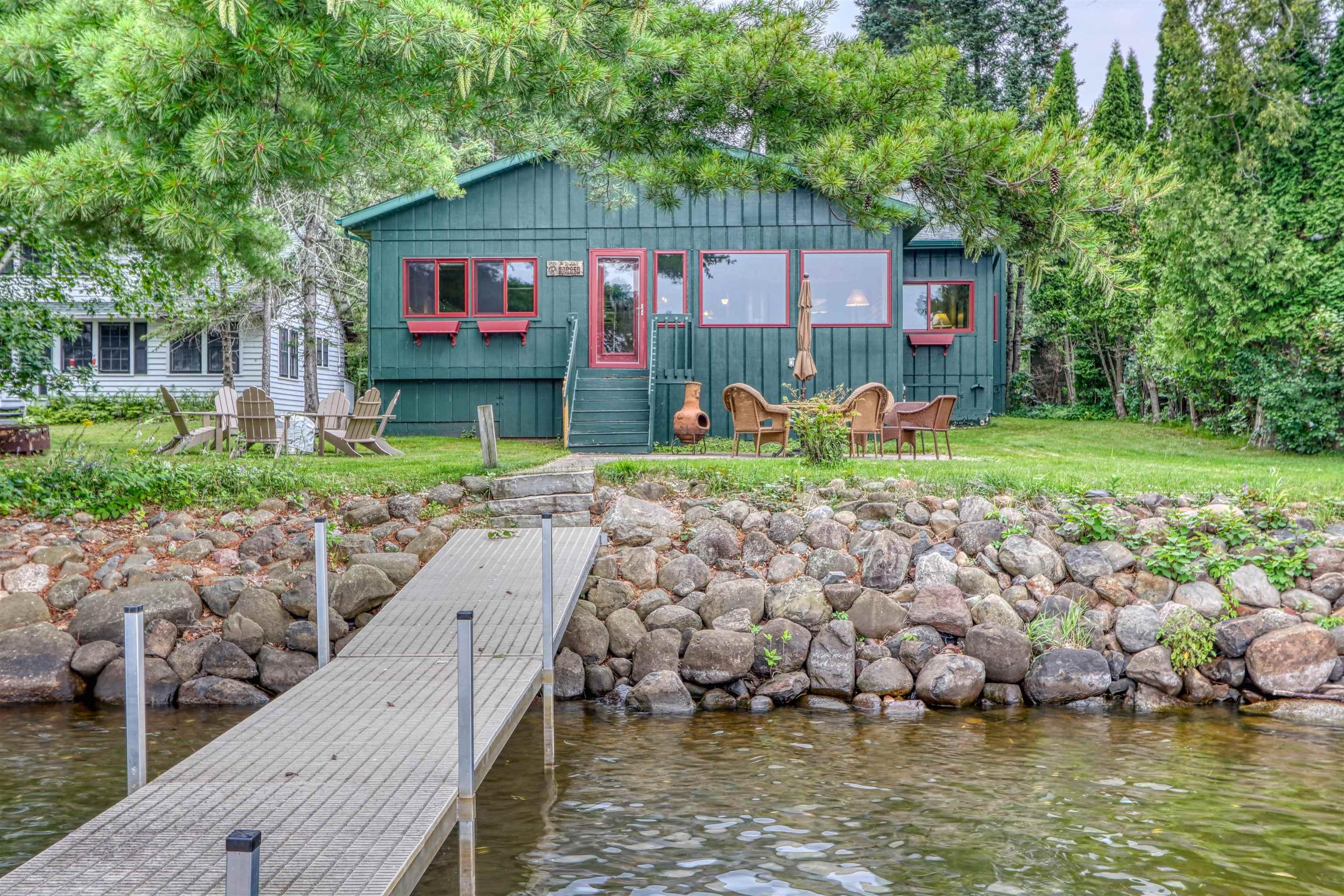 Image 3: Dock area featuring a water view and a yard, Dock