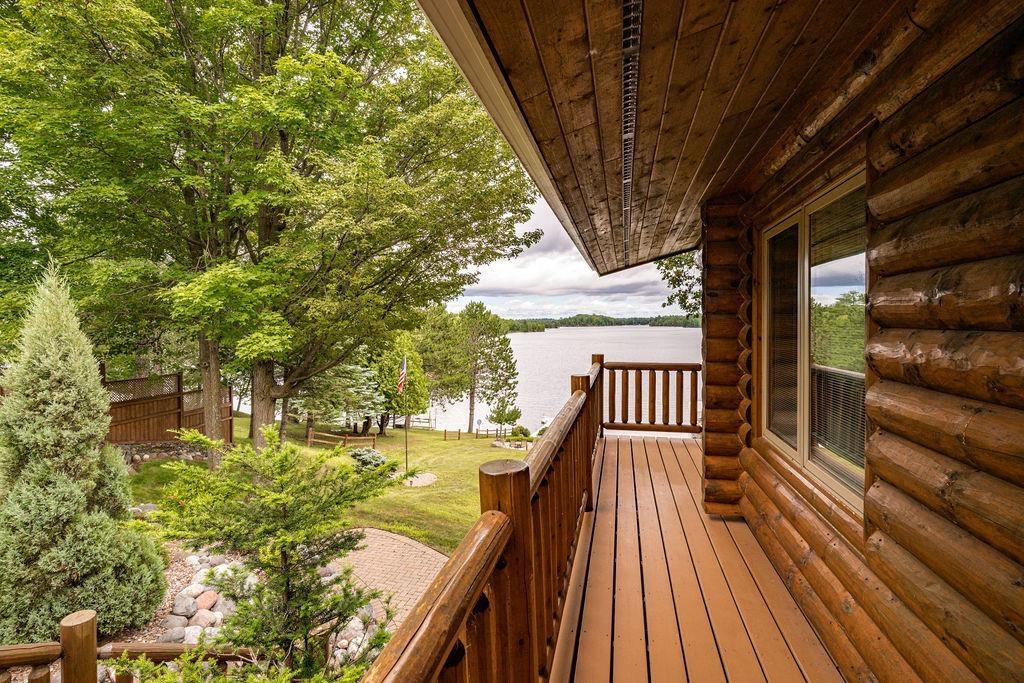 Image 3: Deck featuring a water view and a lawn, Deck