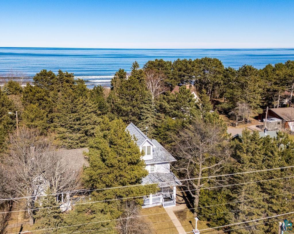 Image 2: Beach Coastal property featuring a multi-story residence with a light-colored exterior and a gray shingle roof, Aerial View