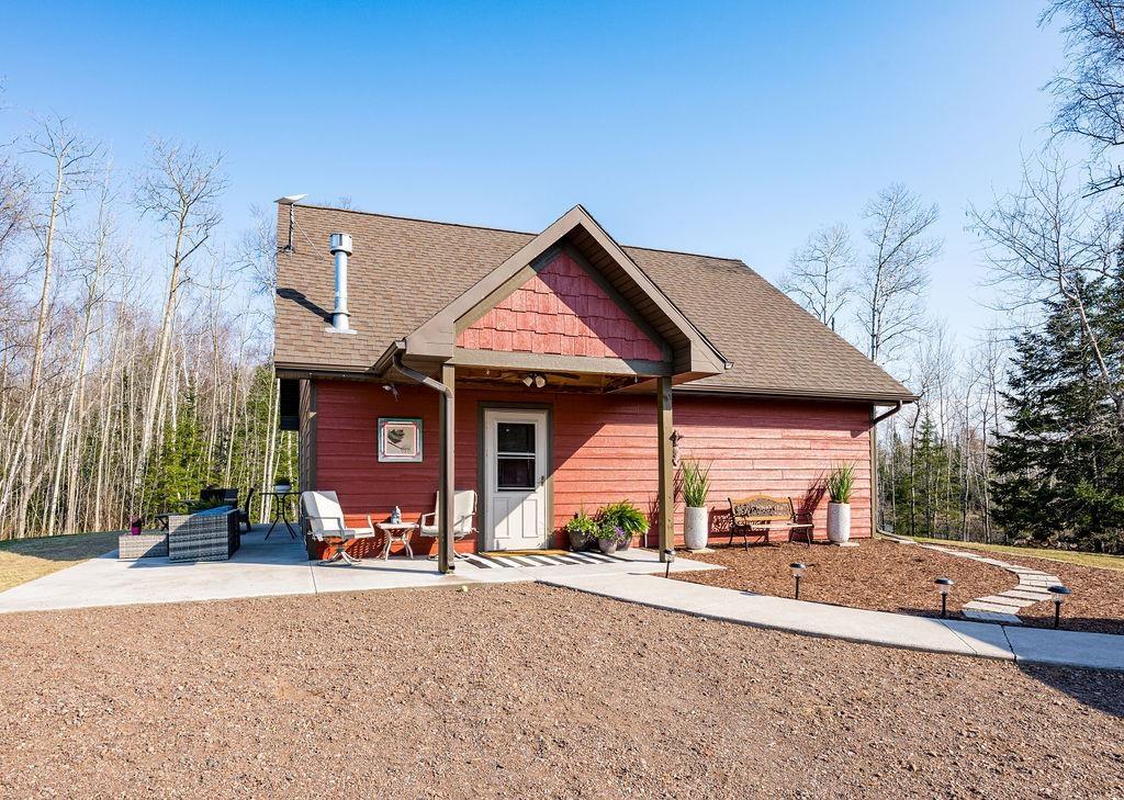 Image 0: View of front of home featuring a patio and roof with shingles, Front Of Structure