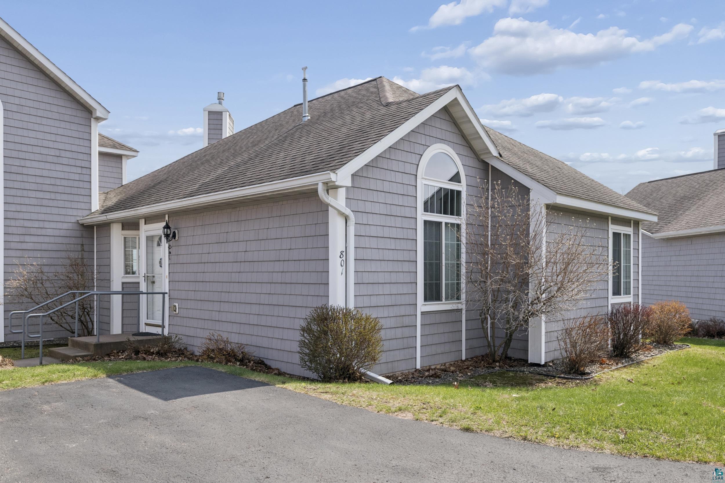 Image 3: Shingle-sided exterior featuring a prominent arched window and a gable roofline, Side Of Structure
