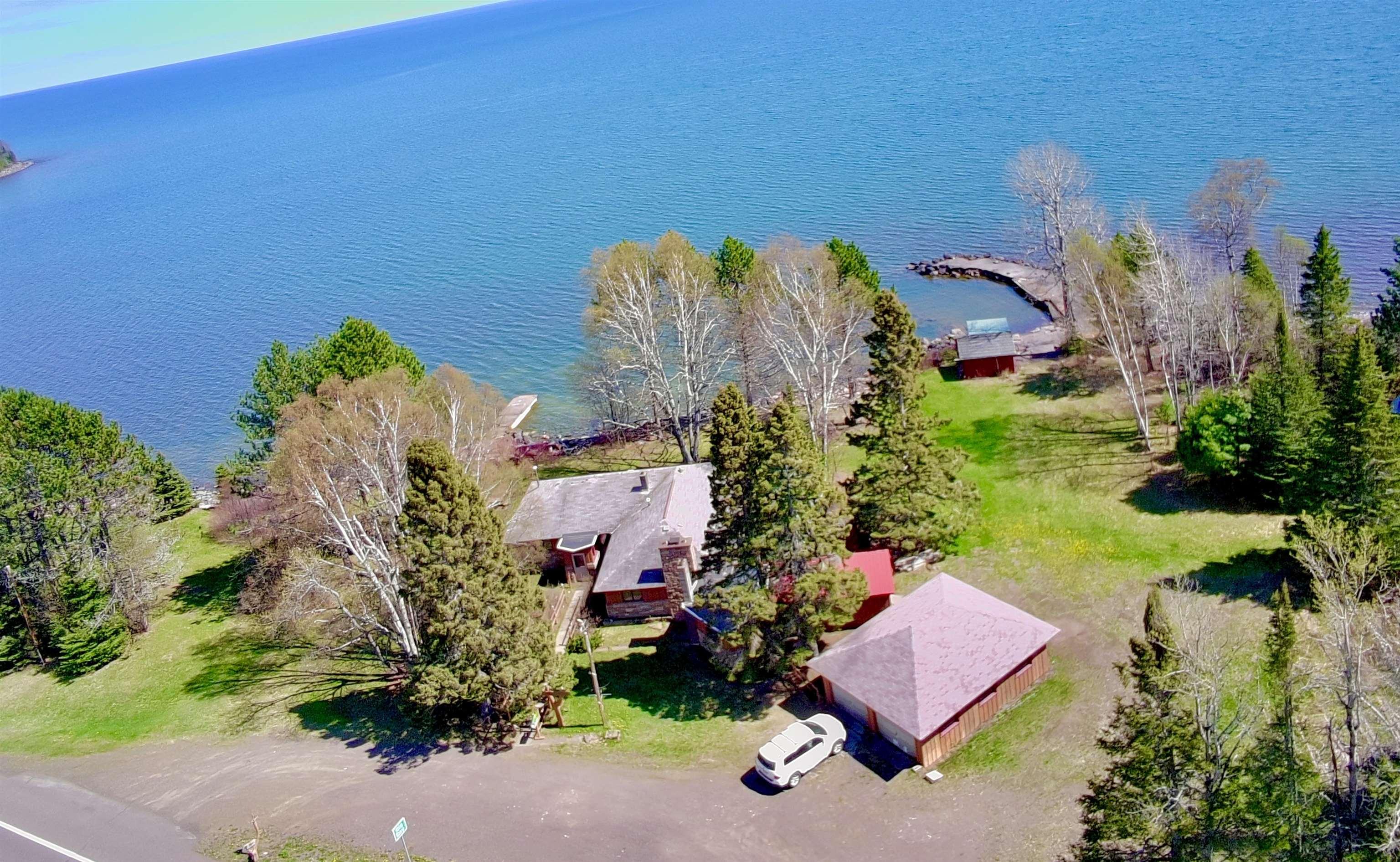 Image 0: View of property featuring Lake Superior, Front View