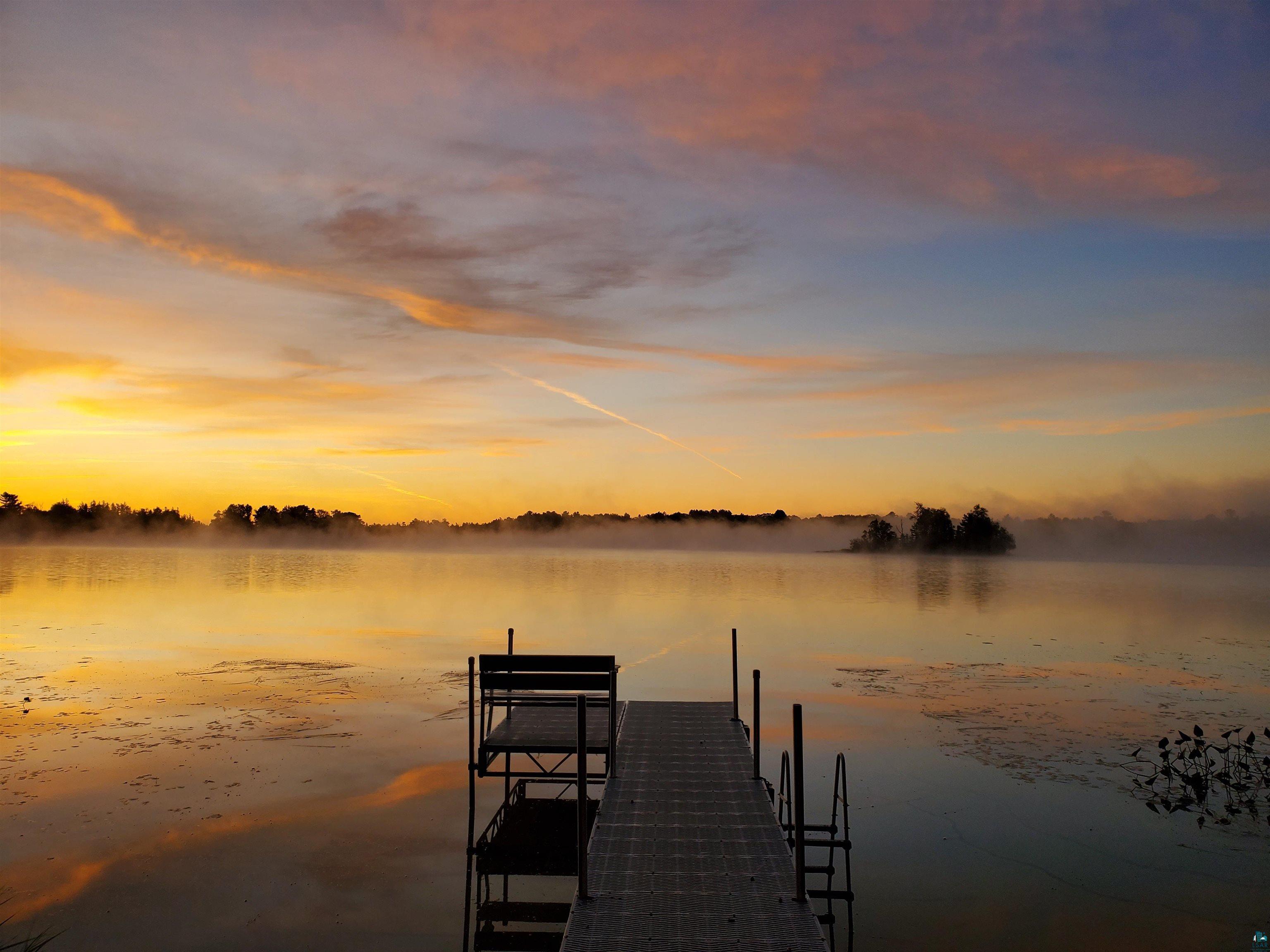 Image 1: Dock area featuring a water view, Dock