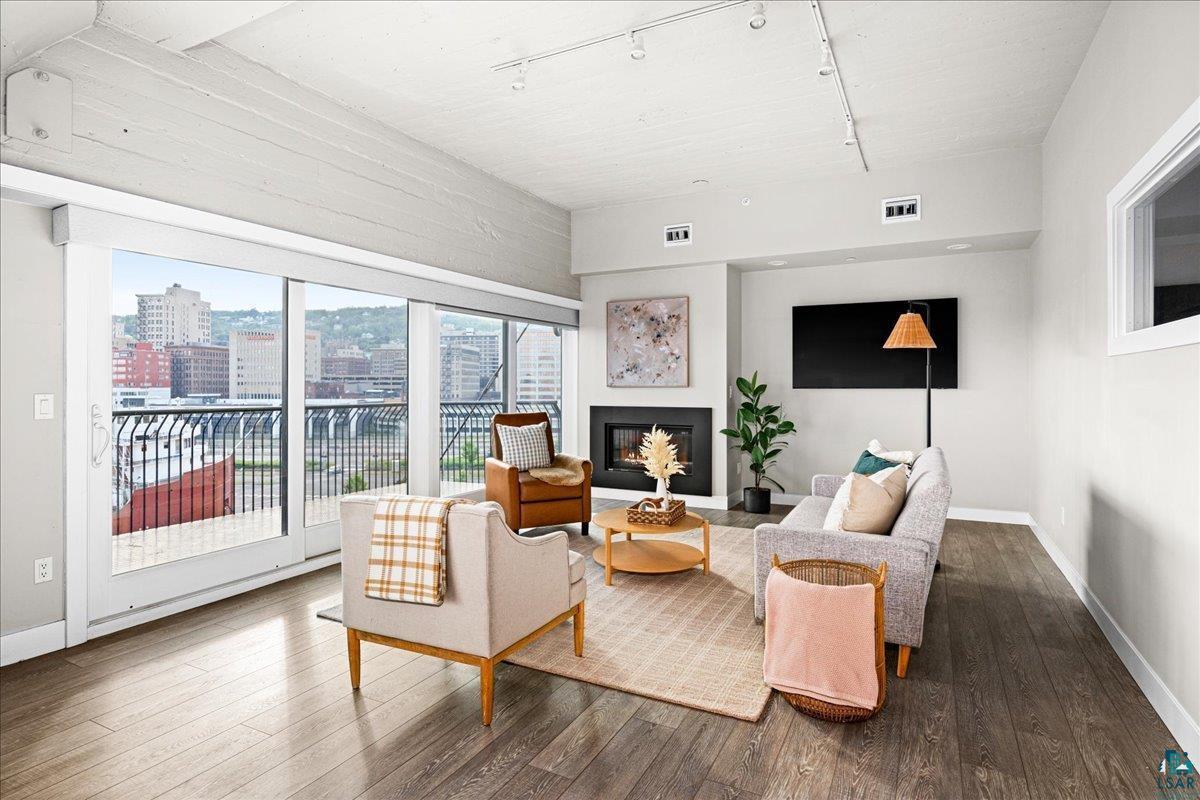 Image 2: Living room featuring rail lighting and wood-type flooring, Living Room