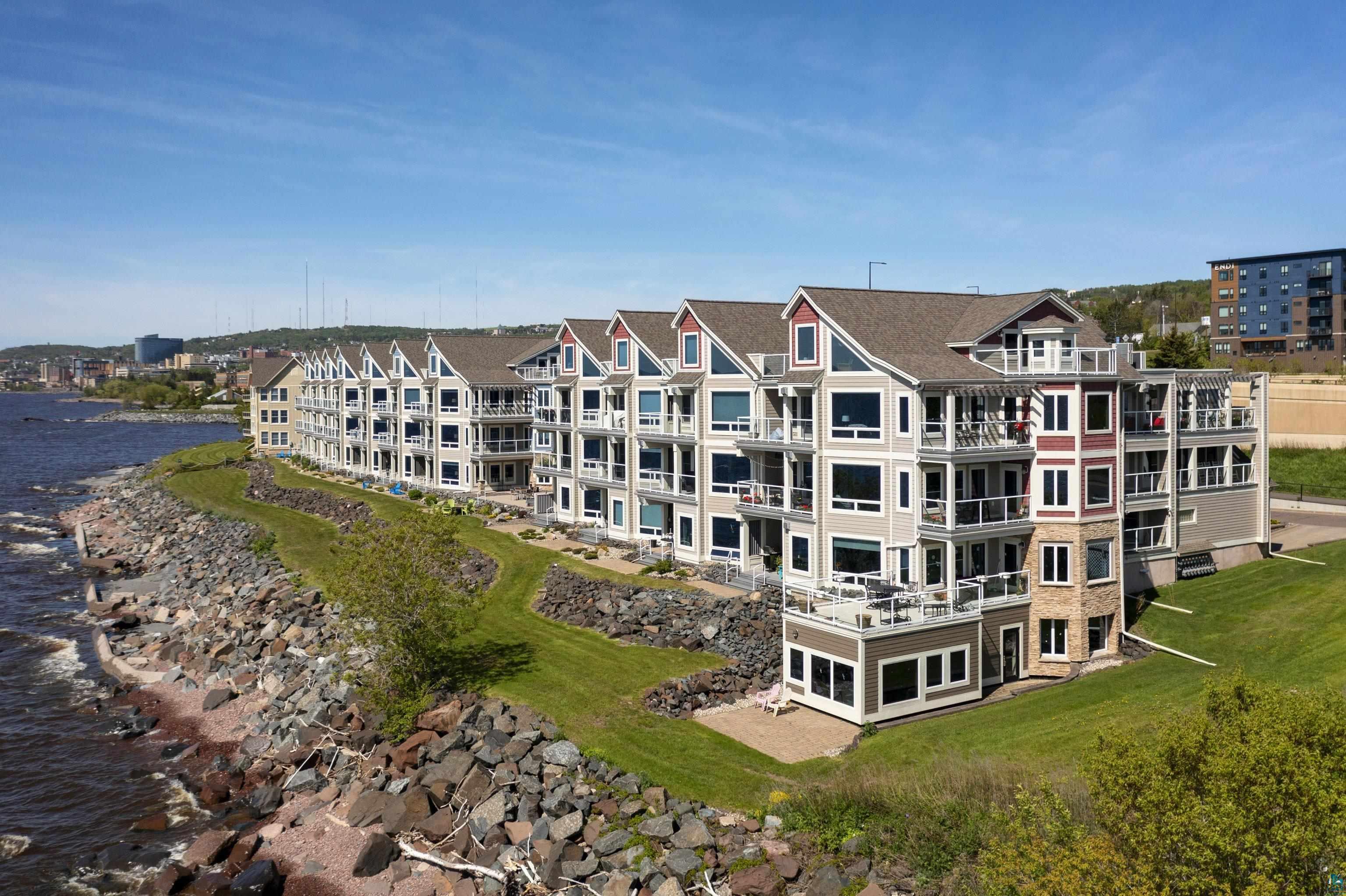 Image 0: View of building exterior featuring a water view, FrontOfStructure