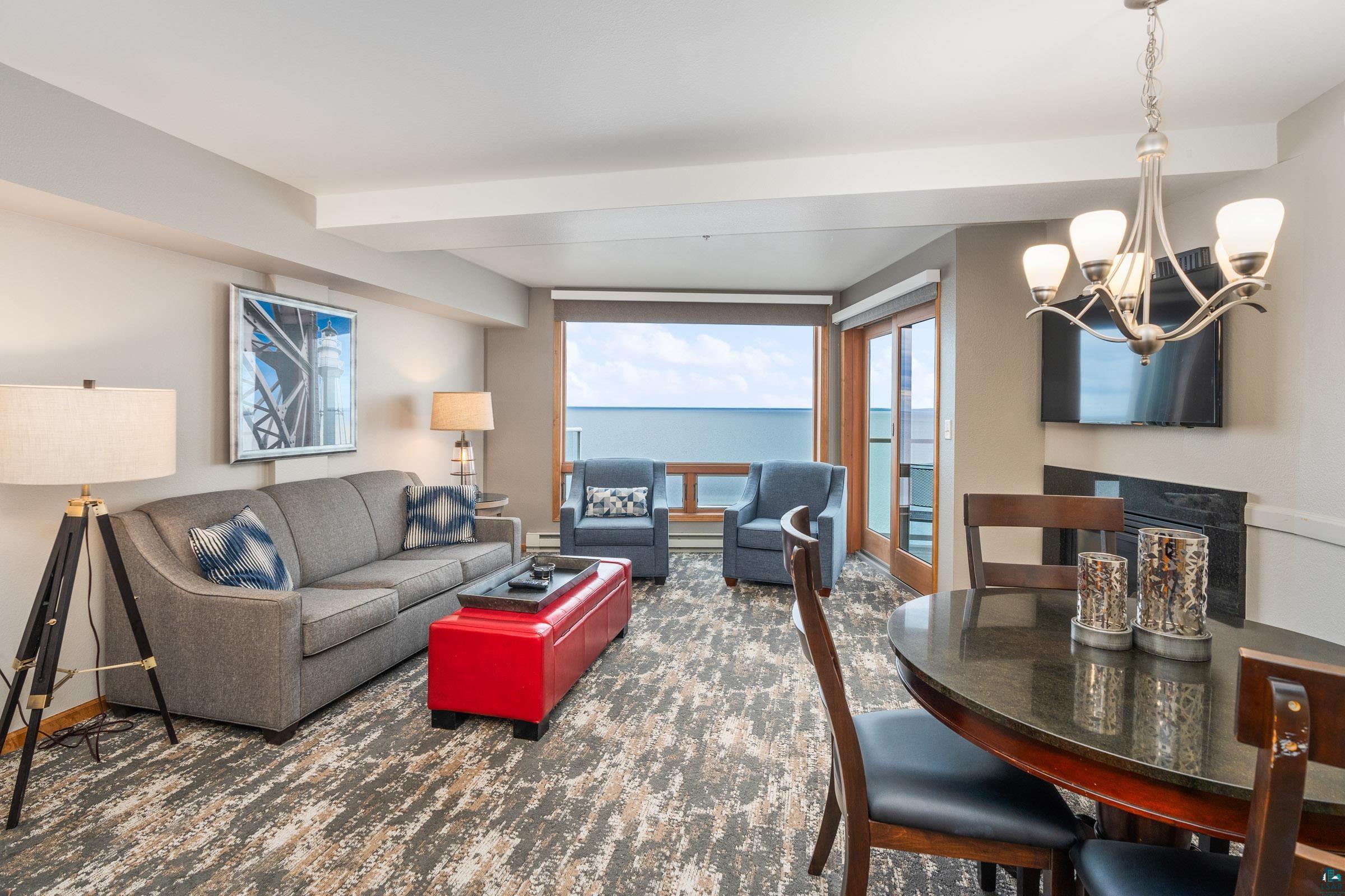 Image 3: Living room featuring an inviting chandelier and a water view, LivingRoom