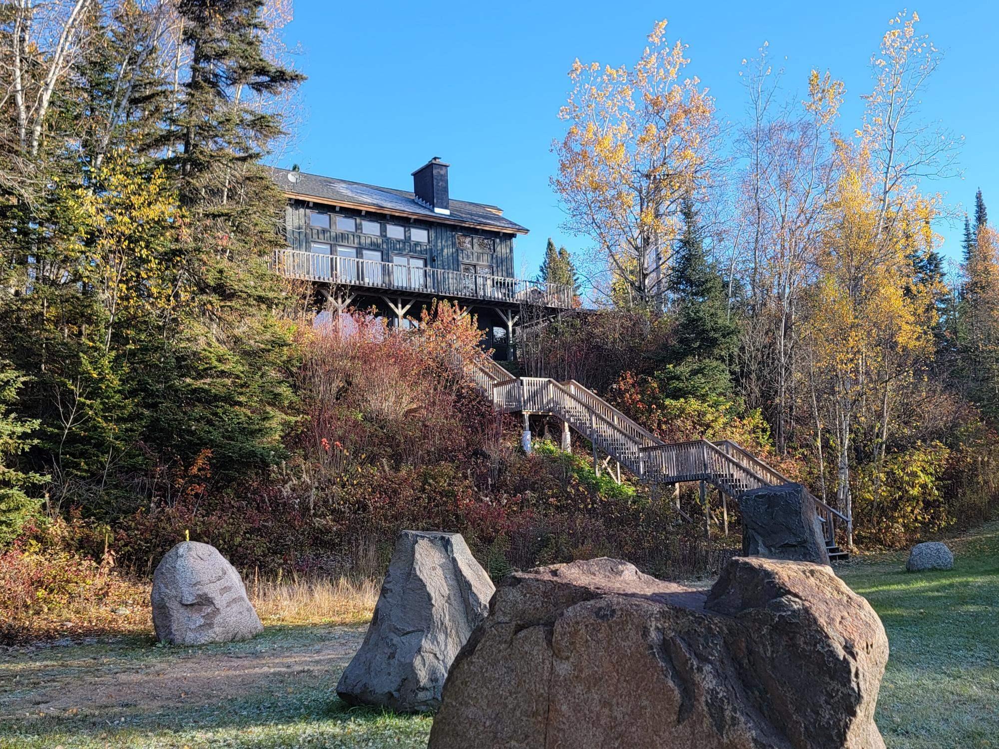 Image 1: Rear view of property featuring a chimney and stairs, Back Of Structure