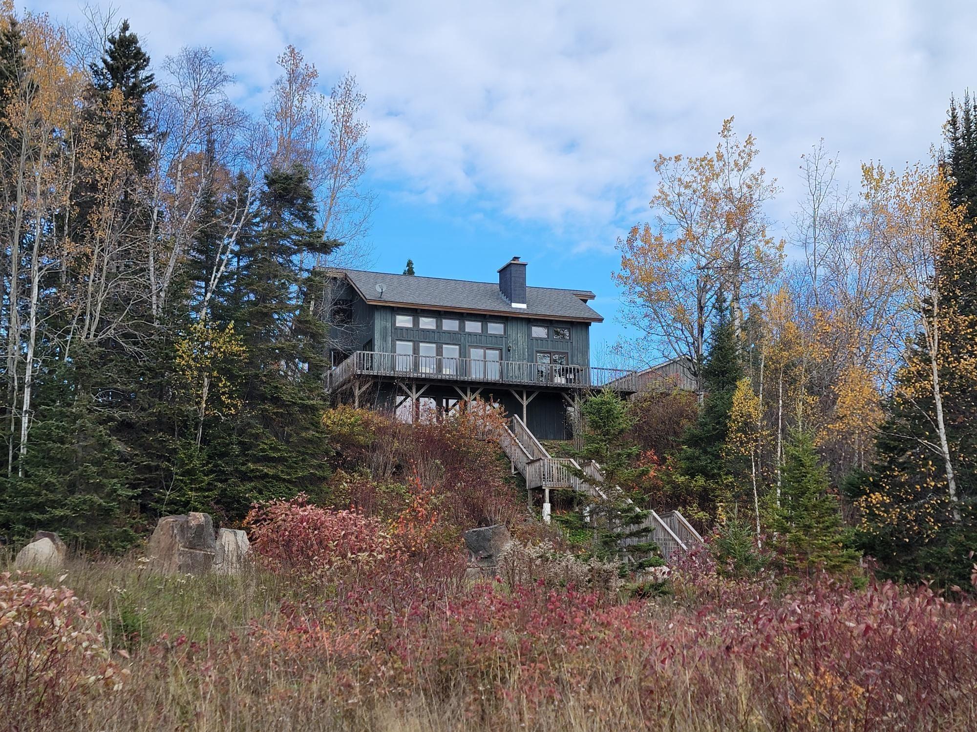 Image 2: Rear view of property with a wooden deck, a chimney, and stairway, Back Of Structure