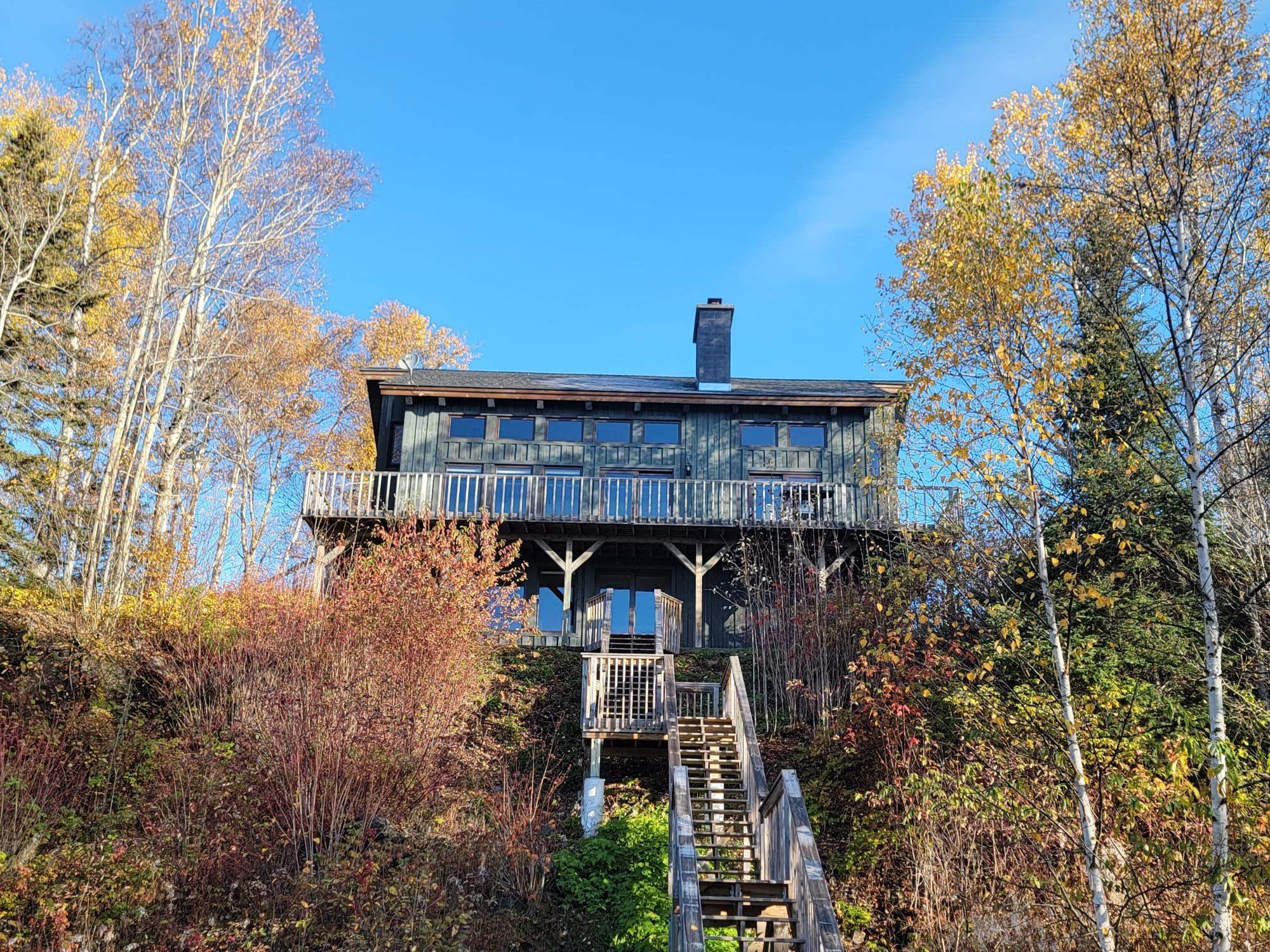 Image 3: Back of house with a chimney, a wooden deck, and stairway, Back Of Structure