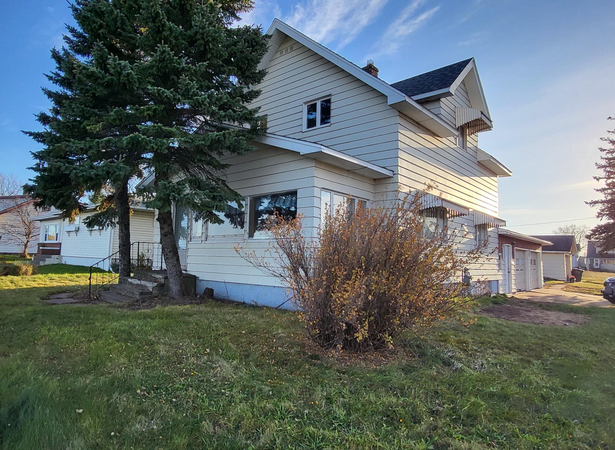 Image 2: View of home's exterior with a yard, a garage, and a shingled roof, Side Of Structure