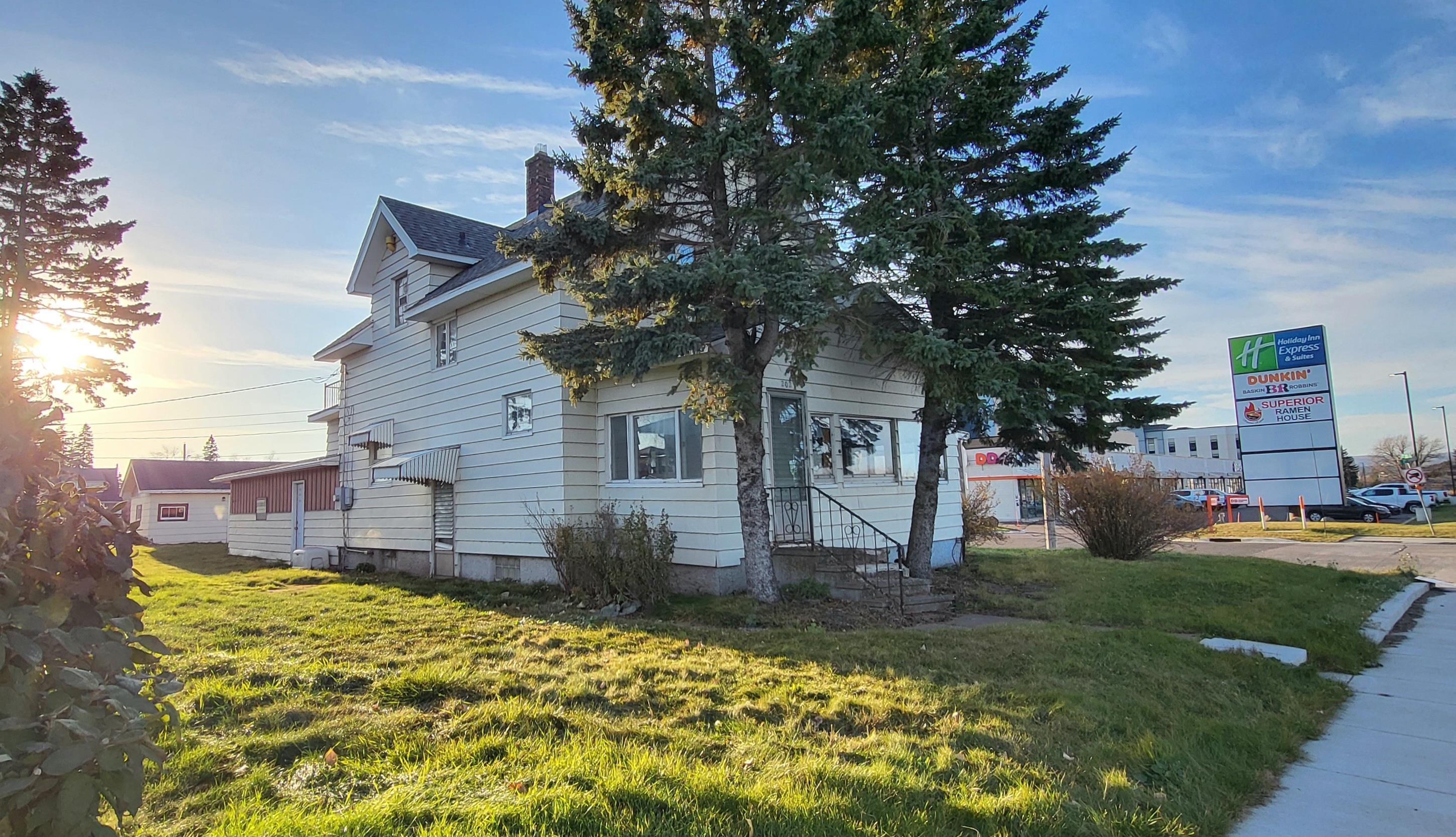 Image 3: View of side of home featuring a yard and a chimney, Side Of Structure