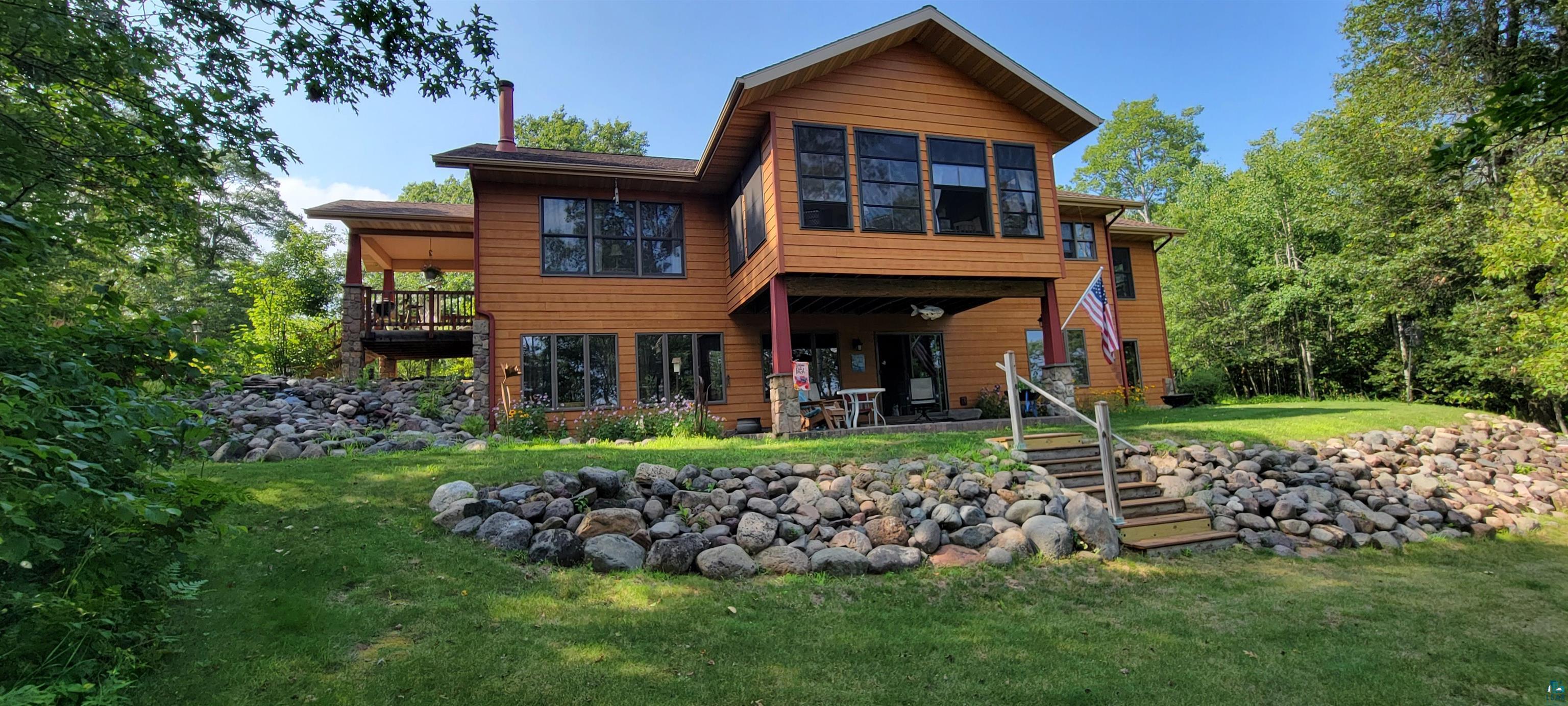 Image 0: Rear view of house featuring a lawn and stairs, Back Of Structure