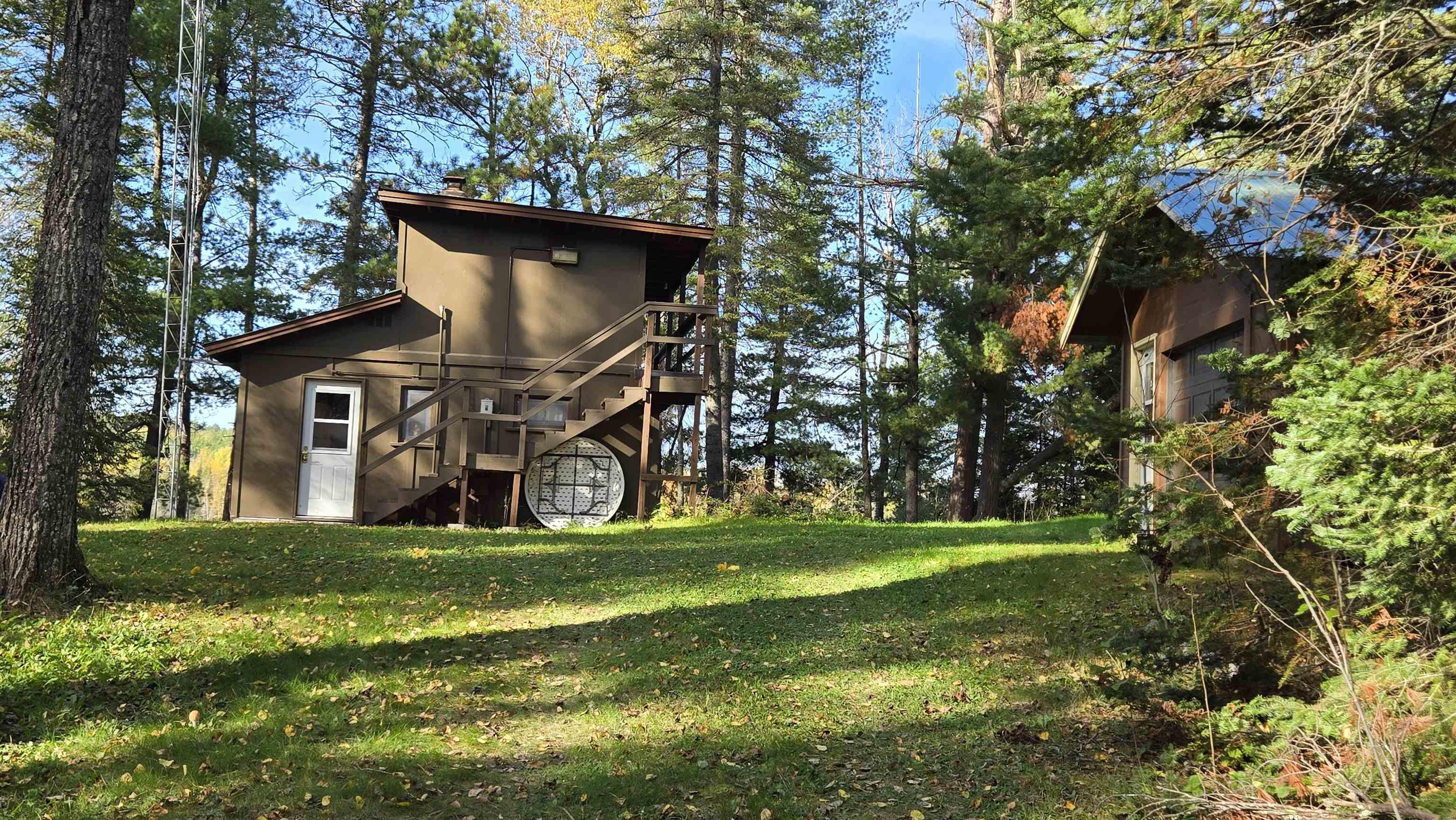 Image 1: Rear view of property featuring stairway, a yard, a deck, and a chimney, Back Of Structure