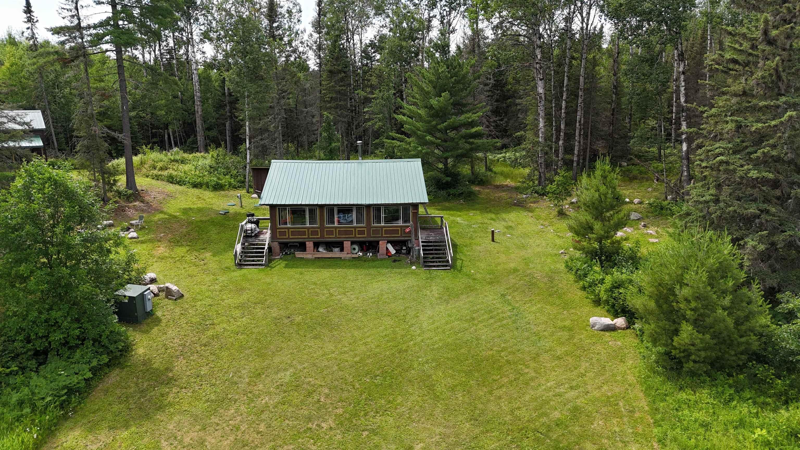 Image 2: View of subject property with a heavily wooded area, Aerial View