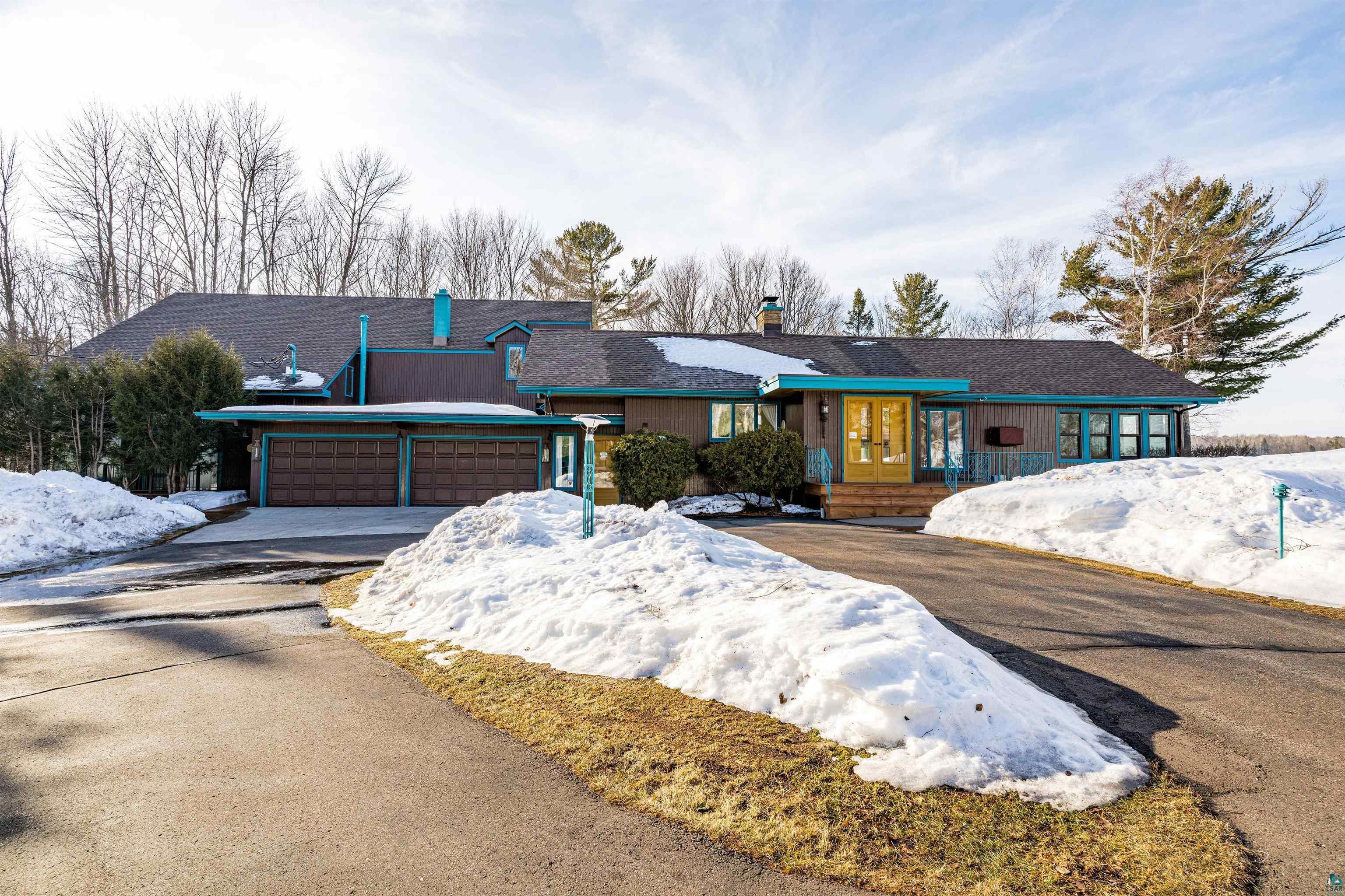 Image 0: Ranch-style home with a chimney, an attached garage, asphalt driveway, and a porch, Main House