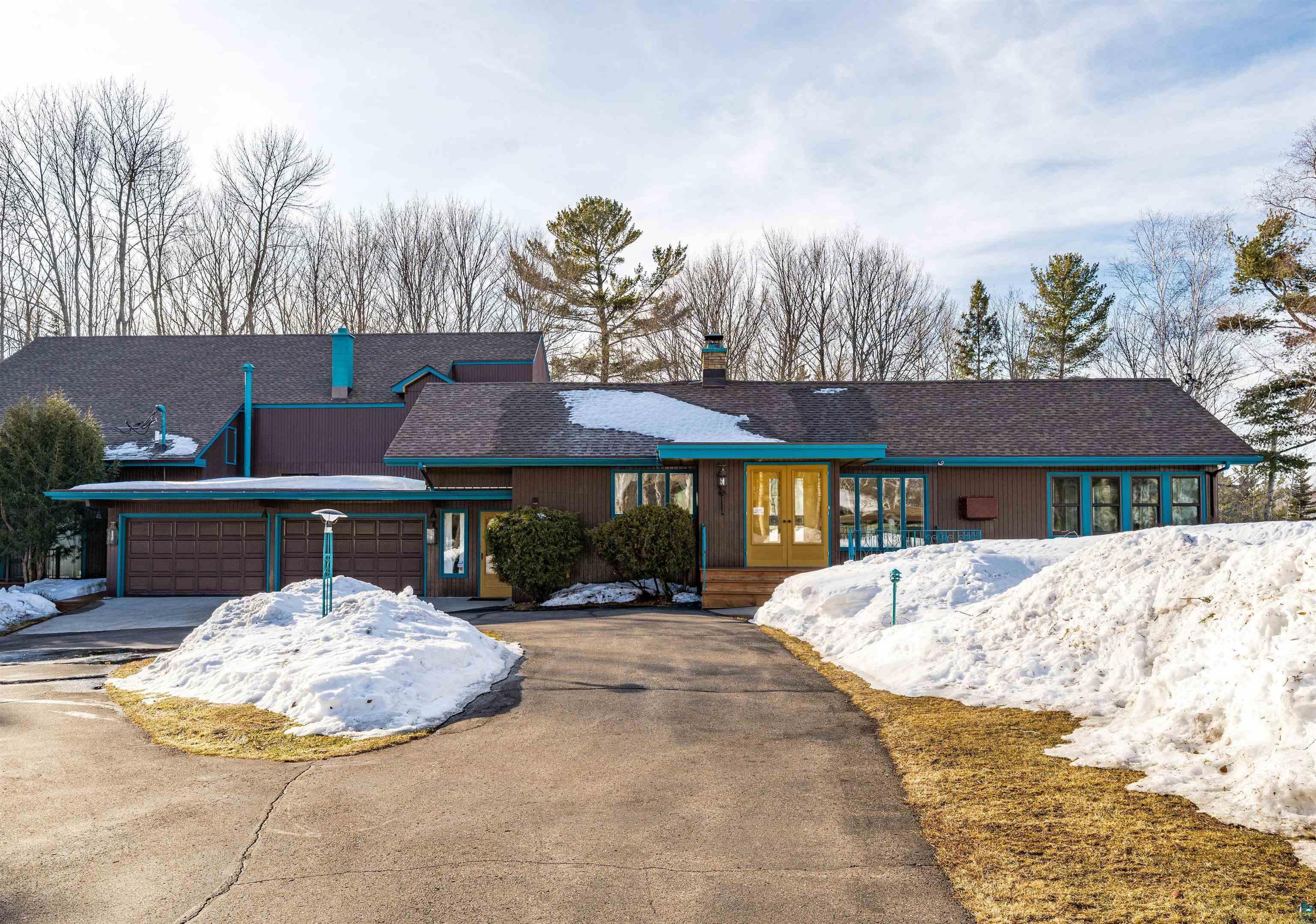 Image 1: View of front of property with driveway, a garage, roof with shingles, and a chimney, Main House