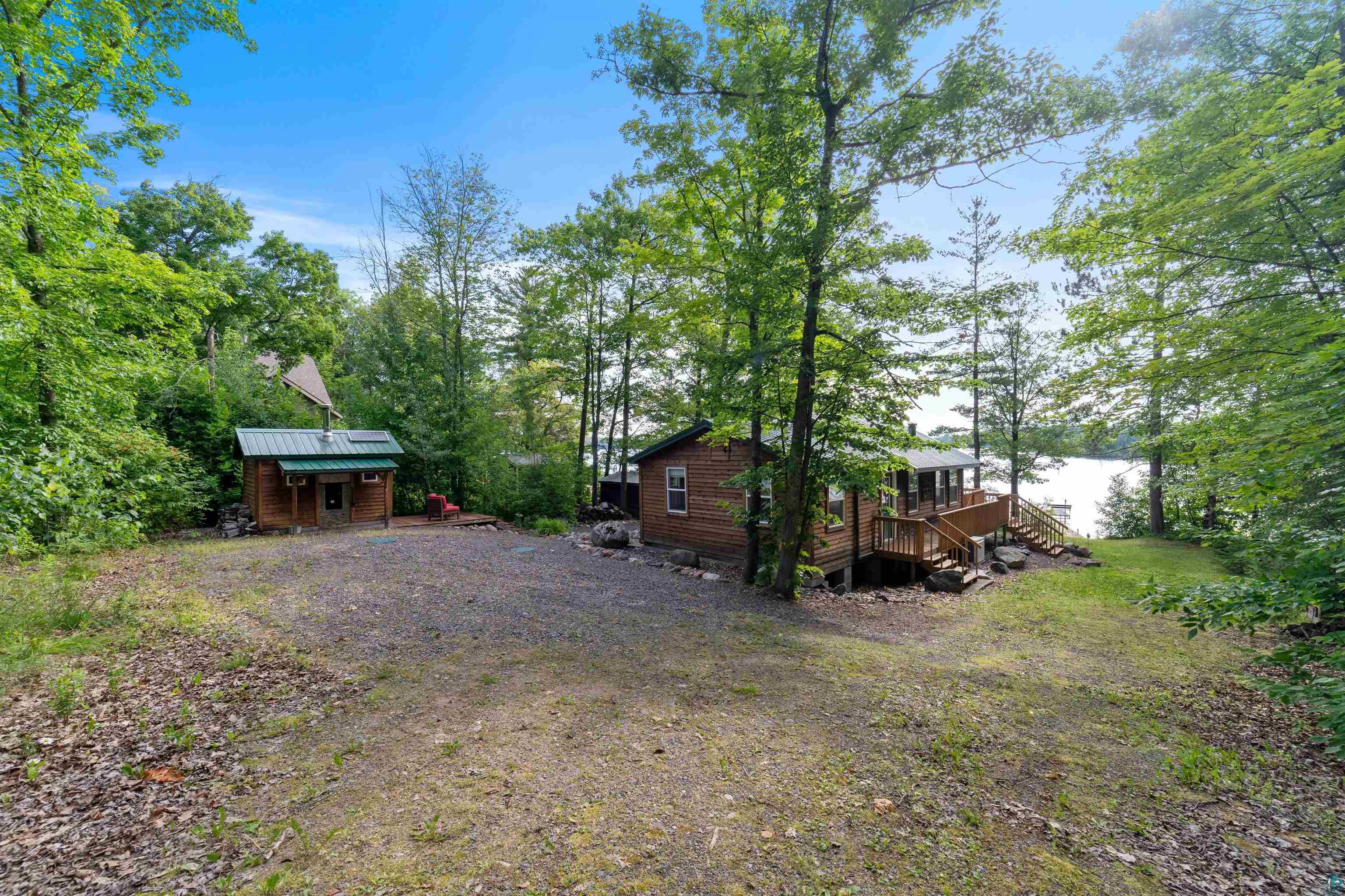 Image 3: View of yard featuring stairway, a deck, and an outdoor structure, Yard